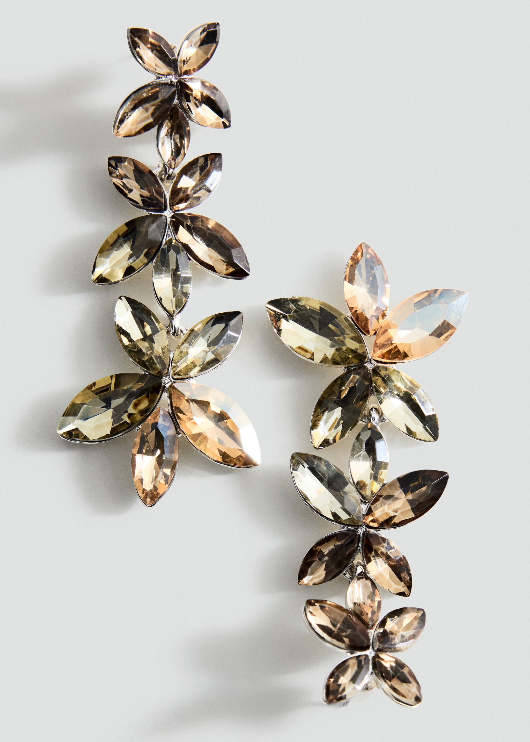 Long crystal floral drop earrings in brown and amber tones.
