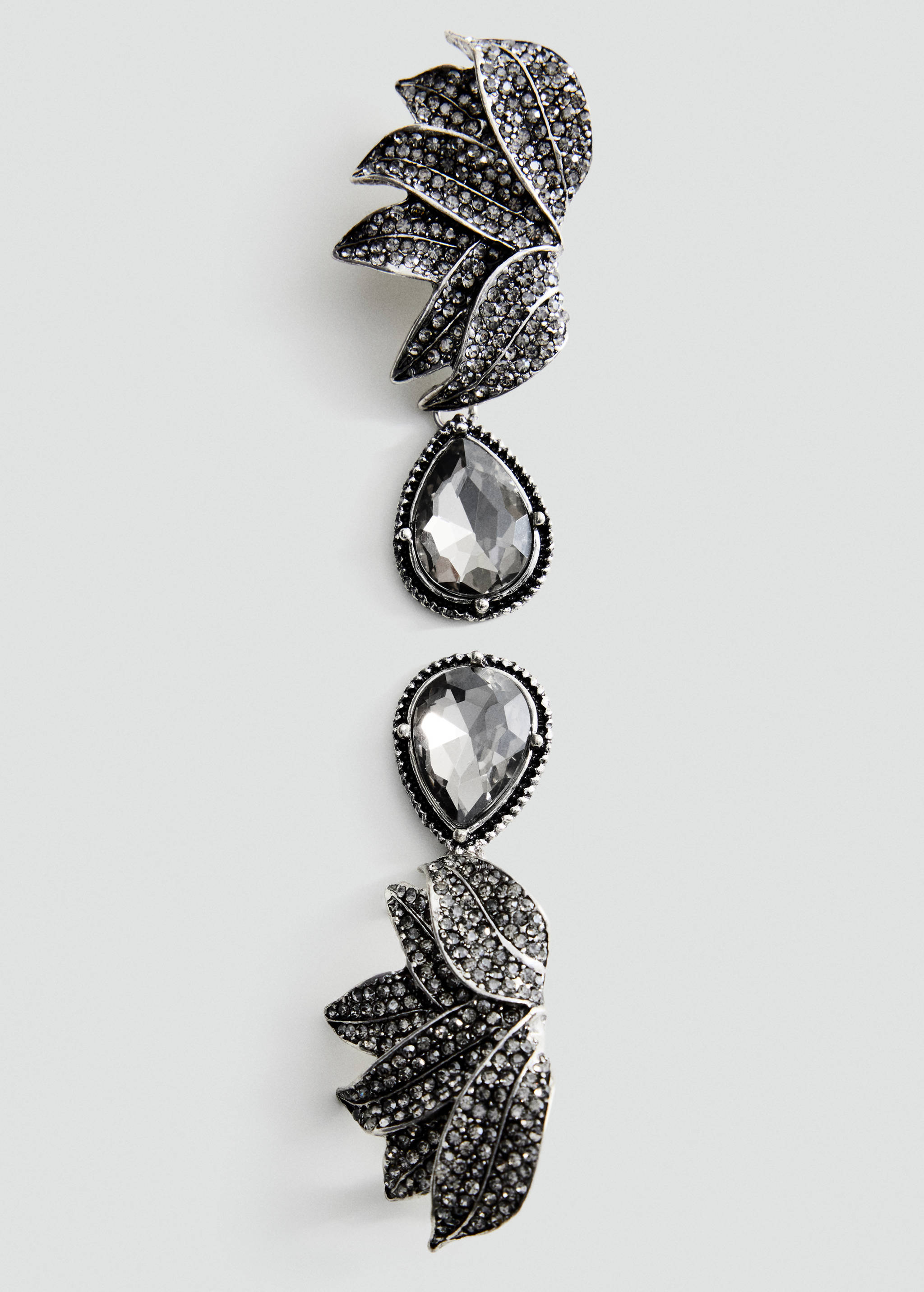 Silver-tone rhinestone dangling earring with leaf and pear-shaped crystal details.