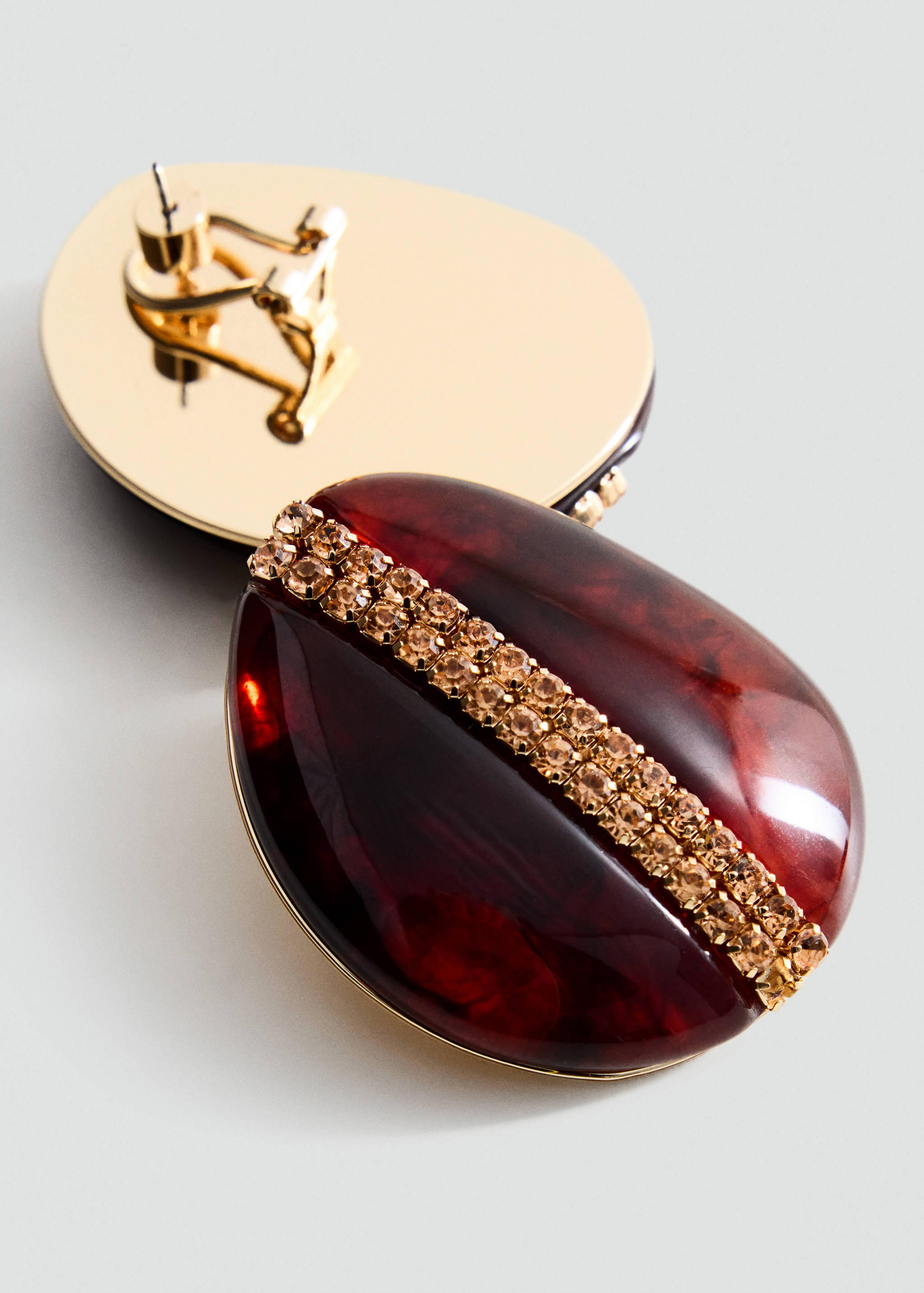 Burgundy teardrop earring with rhinestone stripe and gold-tone backing.