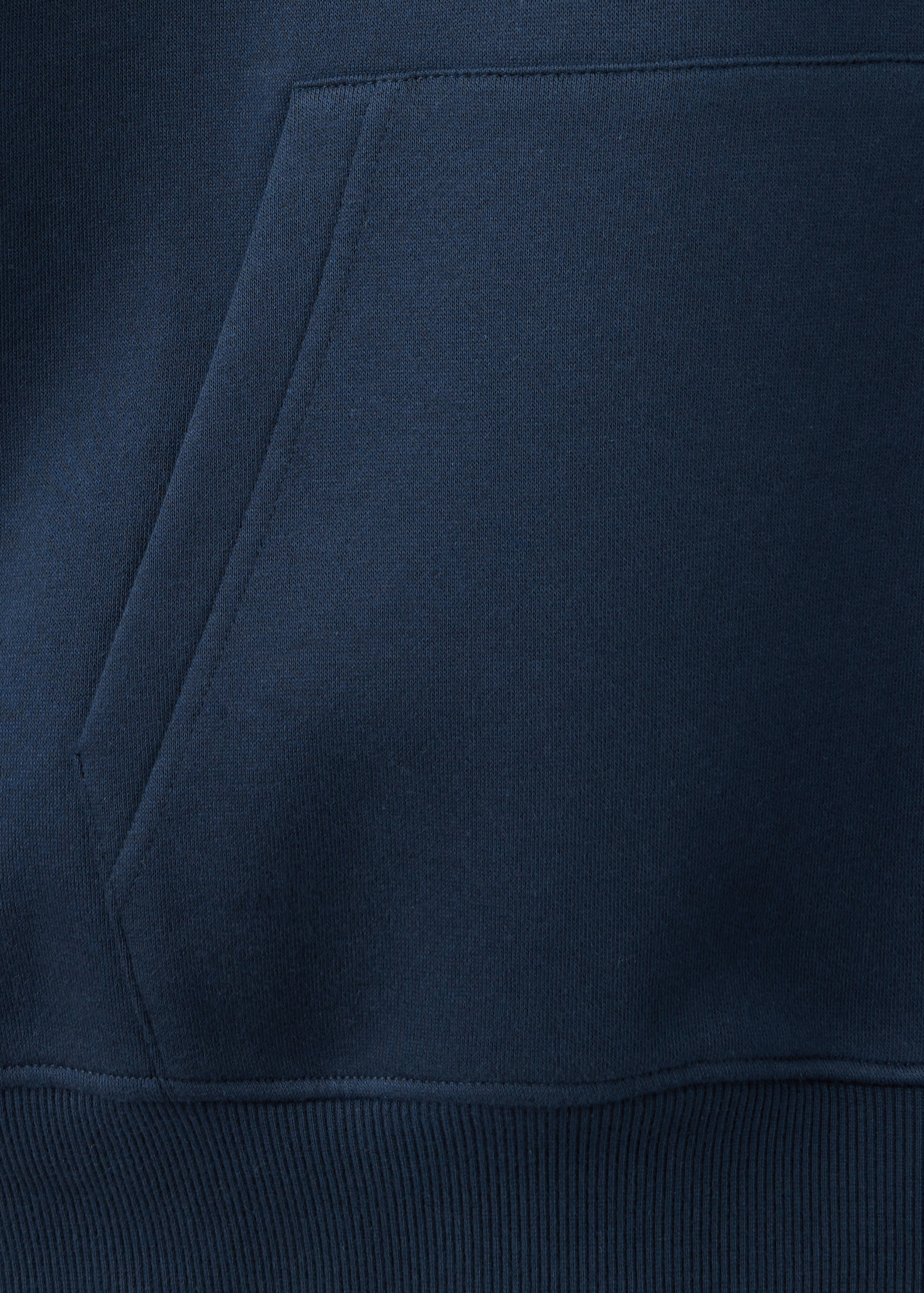 Close-up of a navy blue teen sweatshirt showing fabric and pocket detail.