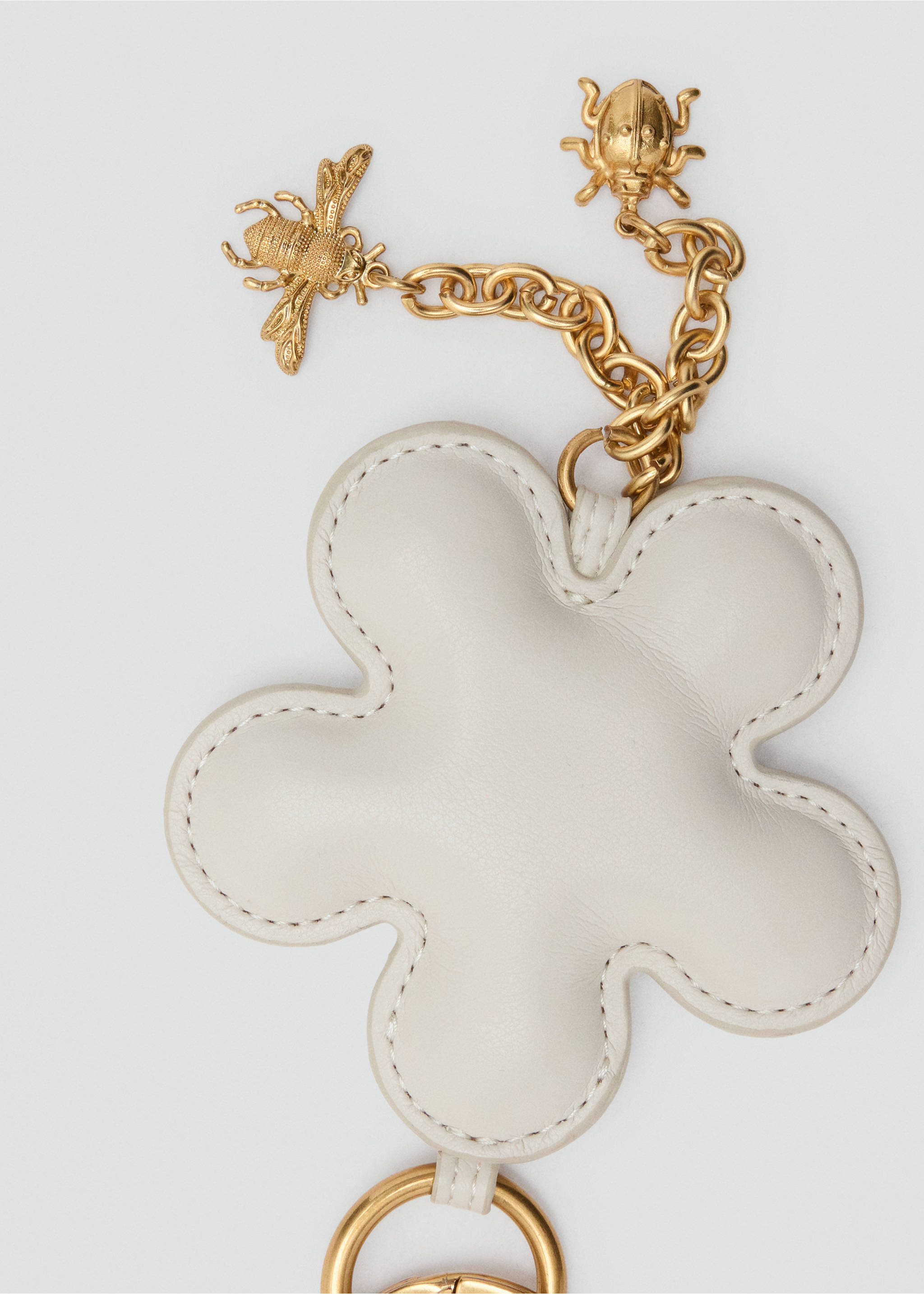 Off-white padded flower-shaped keychain with gold bee and ladybug charms., Off White. Ref: 37027809-00.