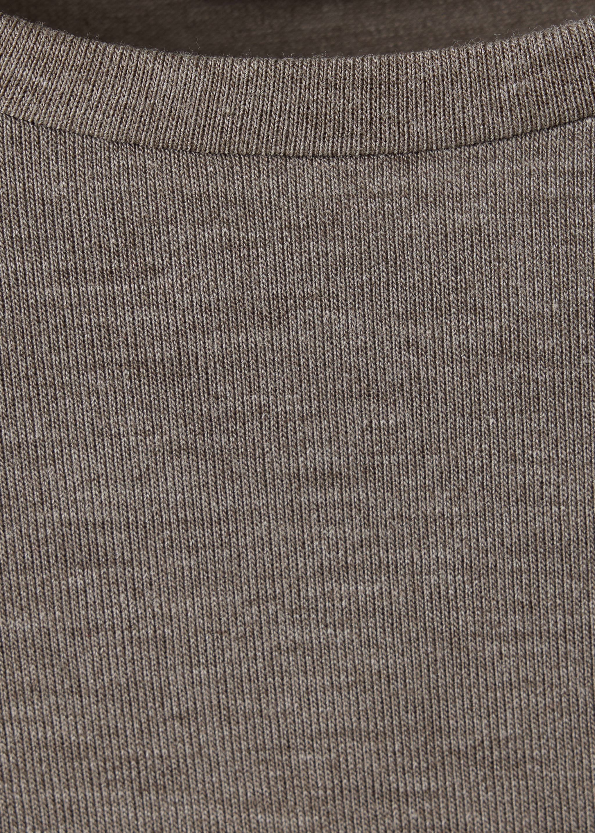 Close-up of a brown t-shirt showing the ribbed knit fabric and neckline.