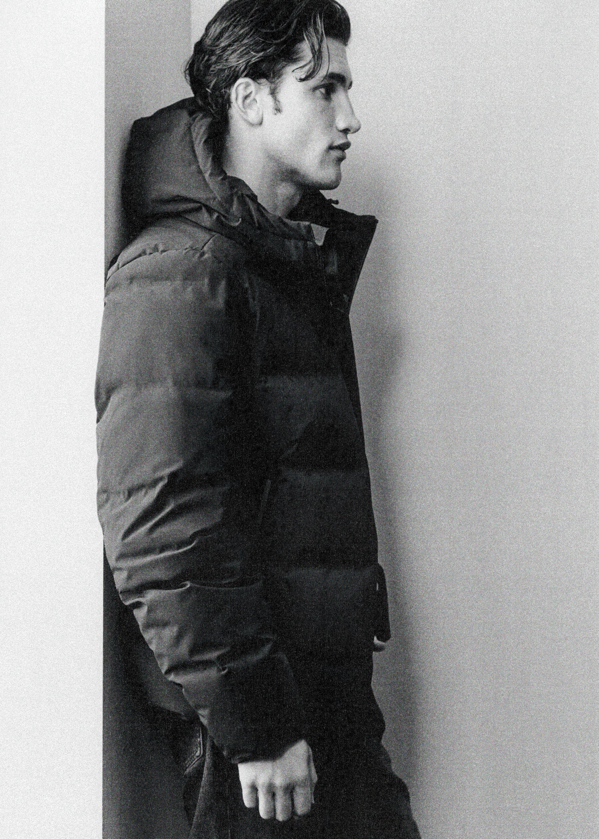 Black hooded puffer anorak in a quilted design.