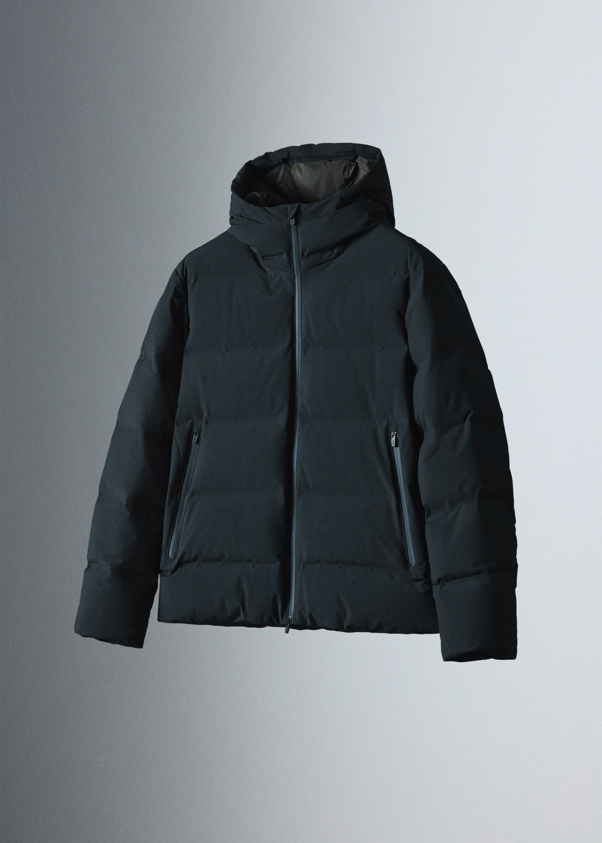 Dark navy blue hooded quilted anorak with zip pockets.