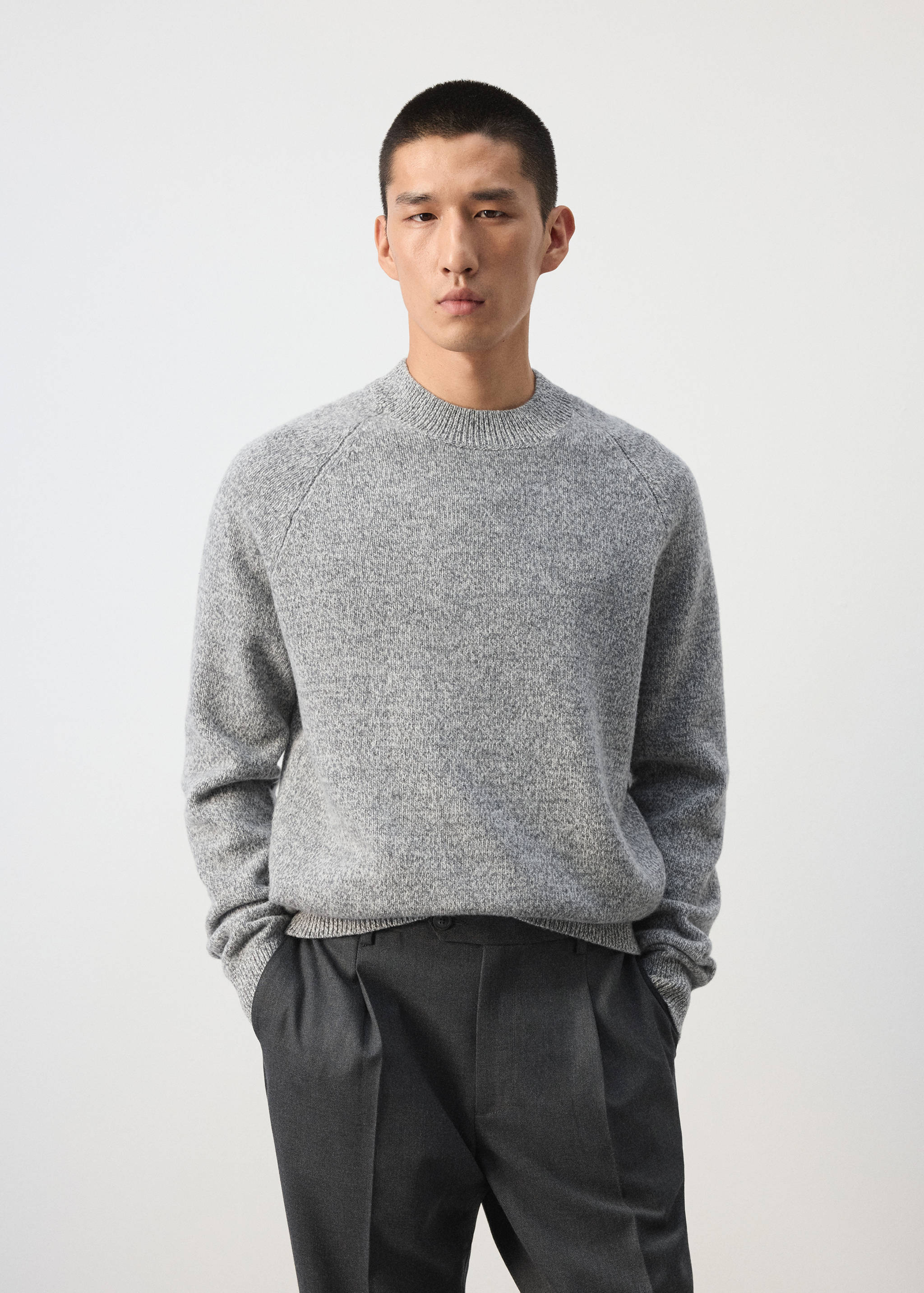 Grey marl crew neck knit sweater with long sleeves.