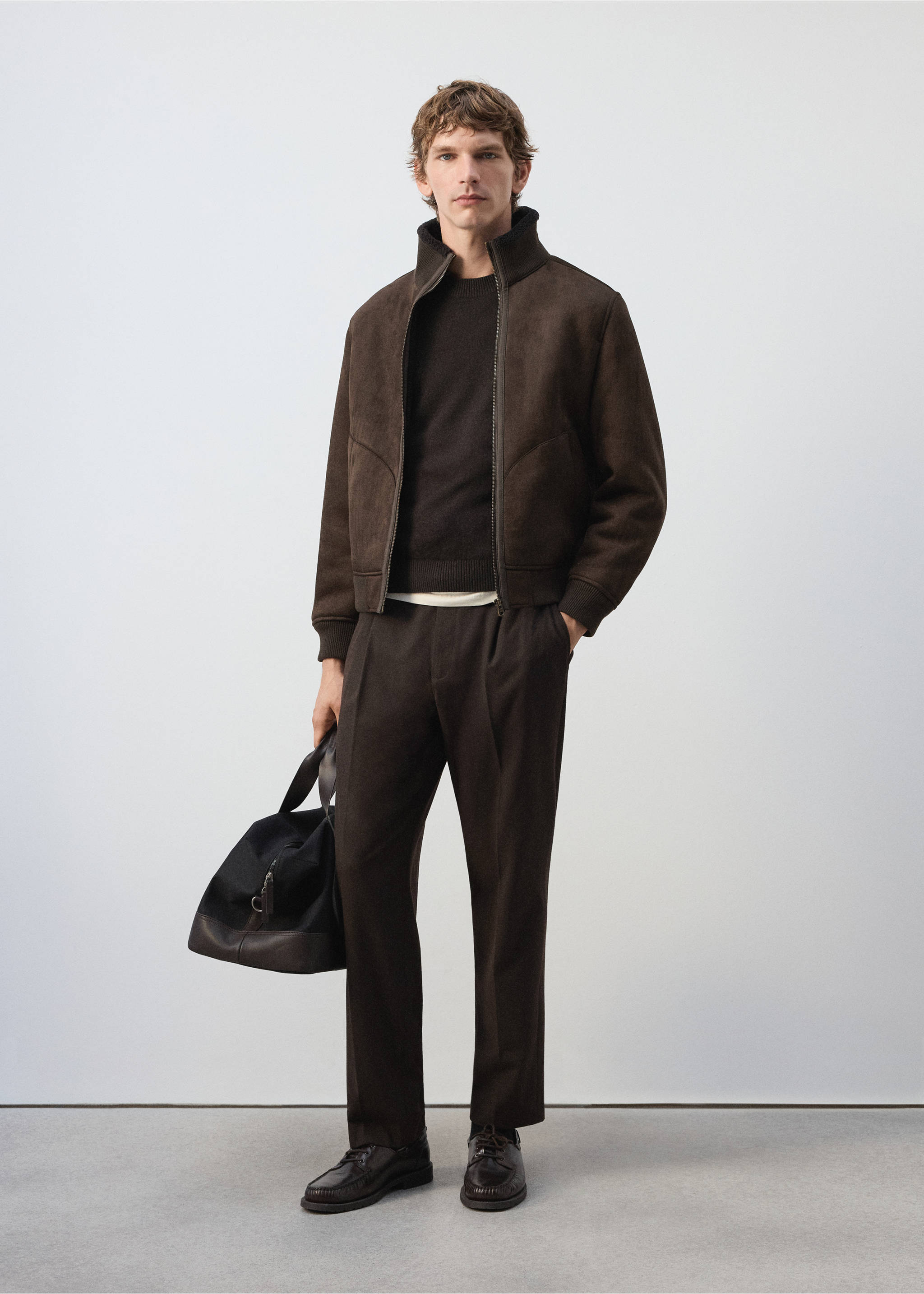 Dark brown zip-up jacket with a high neck, styled with a matching jumper, trousers, and a travel bag., Coffee. Ref: 37027890-00.