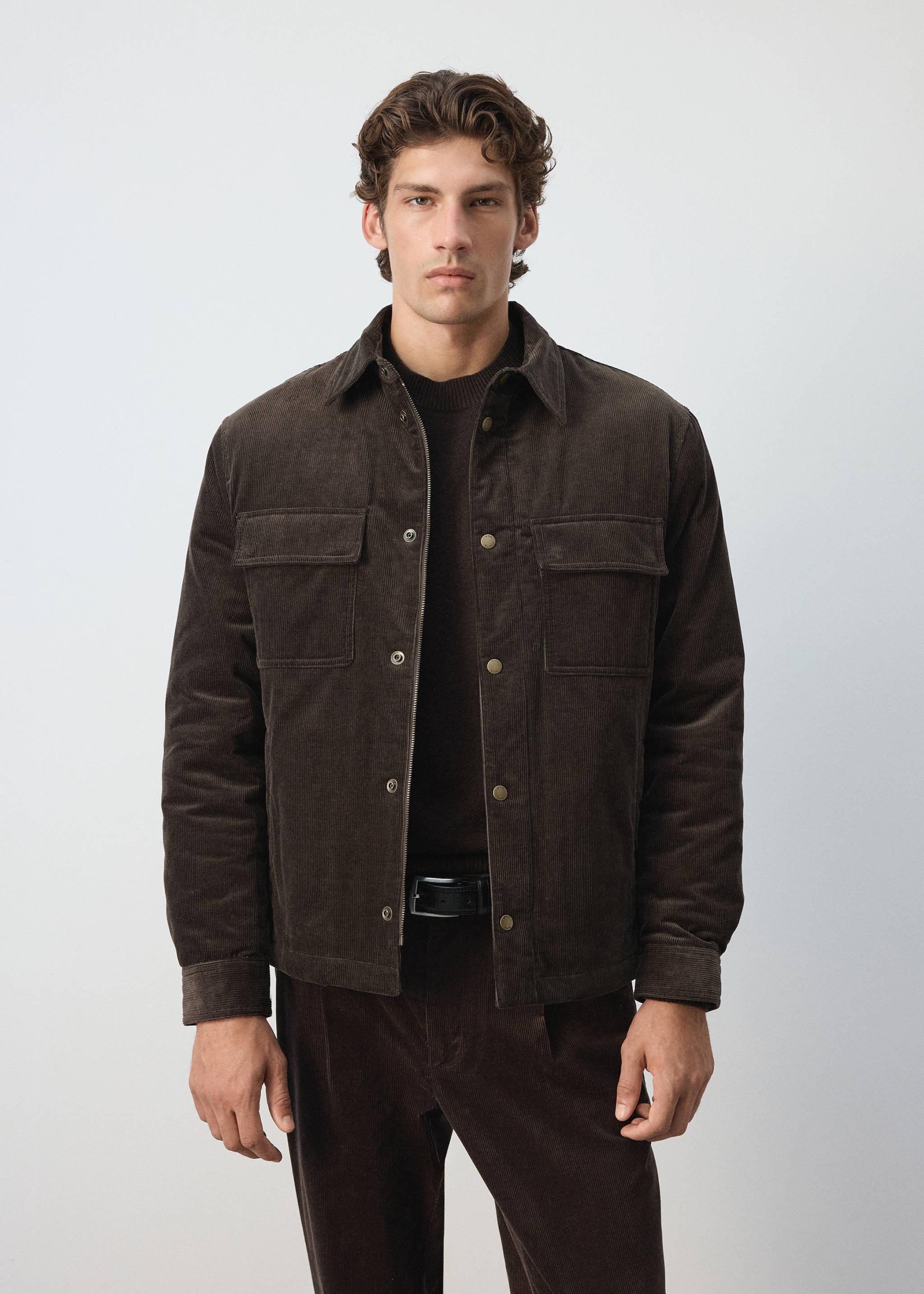 Dark brown corduroy jacket featuring a shirt collar, snap-button closure, and two flap chest pockets.