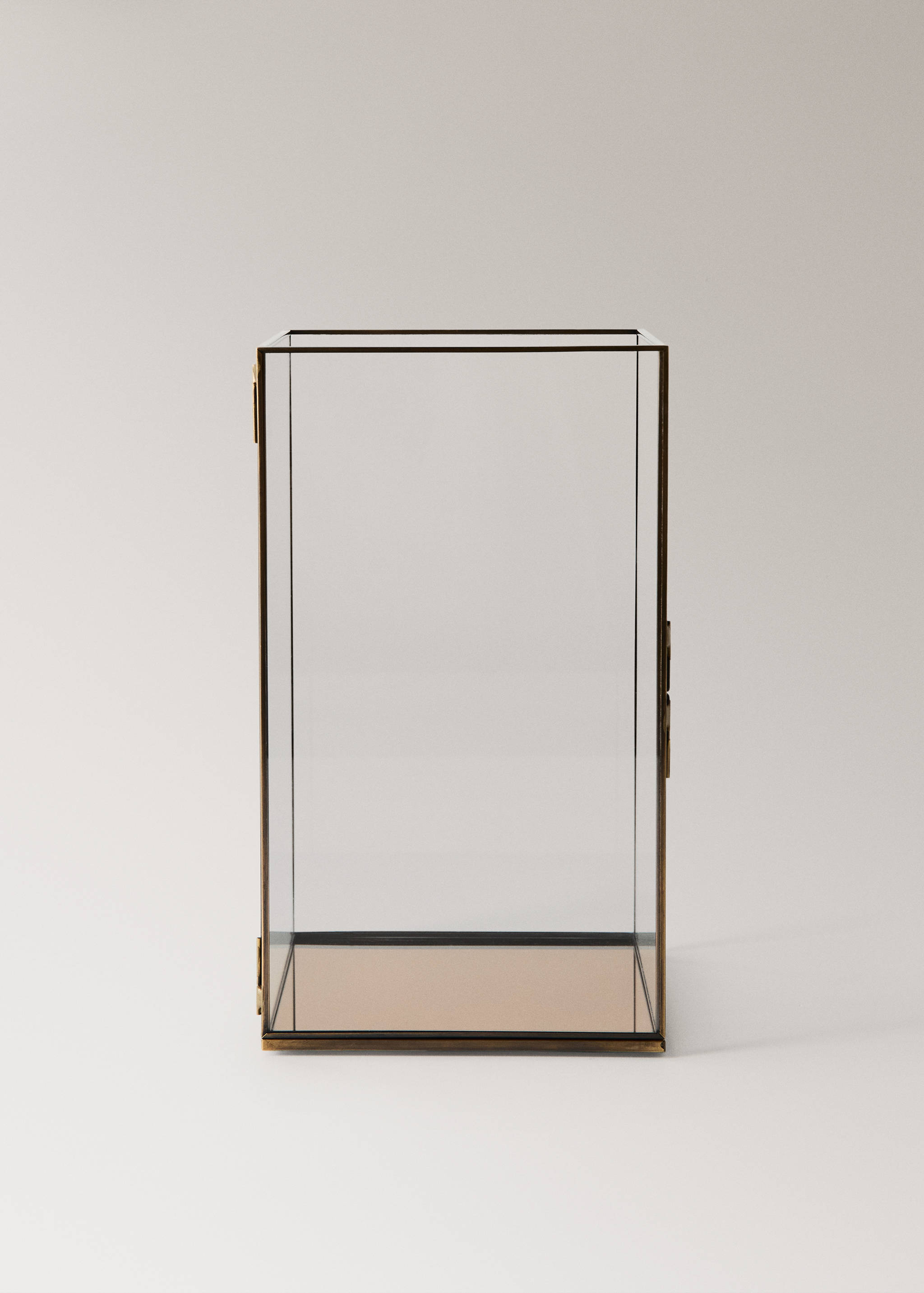 Rectangular glass candle holder with brass frame and mirrored base.