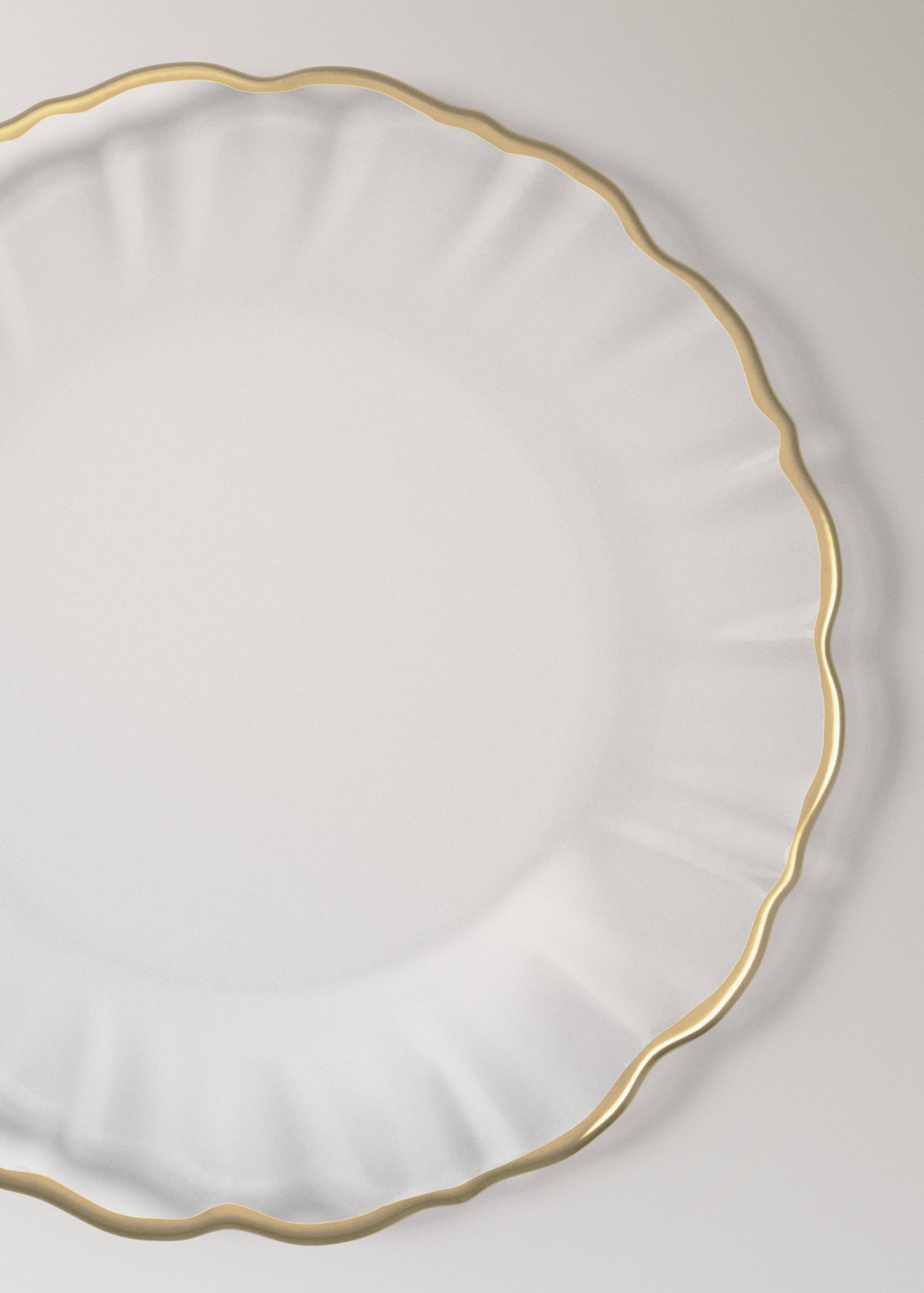 Glass plate with a fluted texture and a gold scalloped rim.