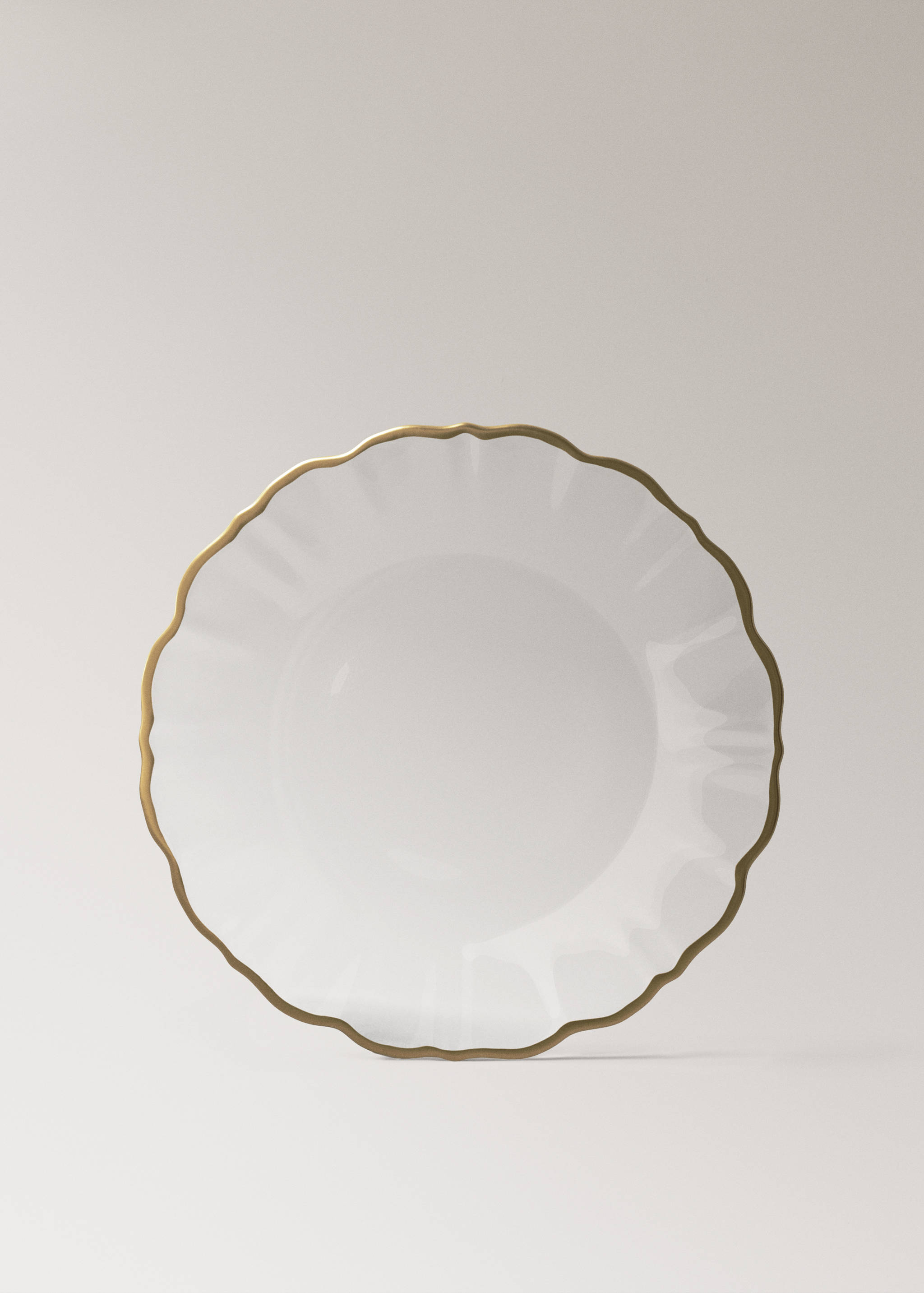 White plate with a scalloped edge and gold rim.