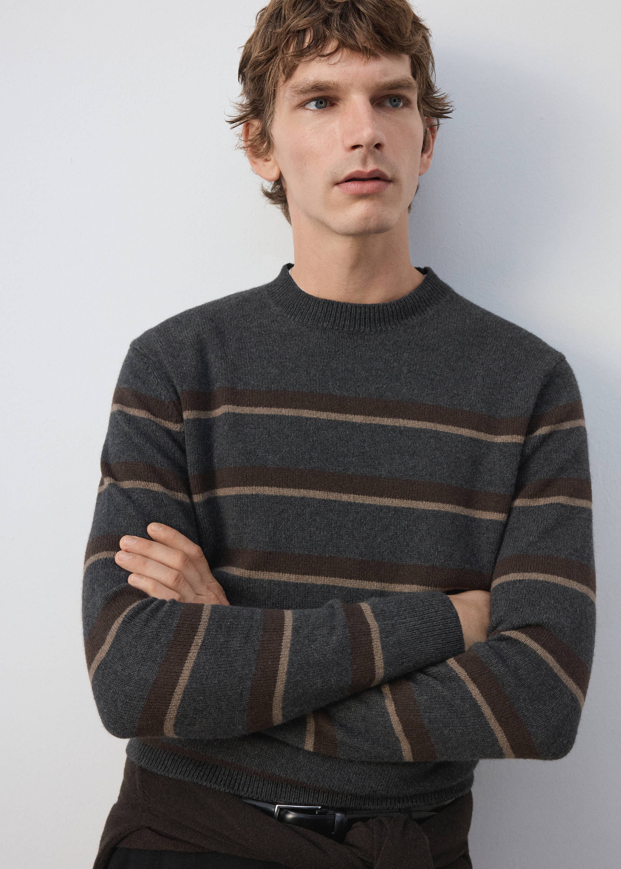 Dark grey knitted jersey with brown and beige horizontal stripes and a ribbed round neck.