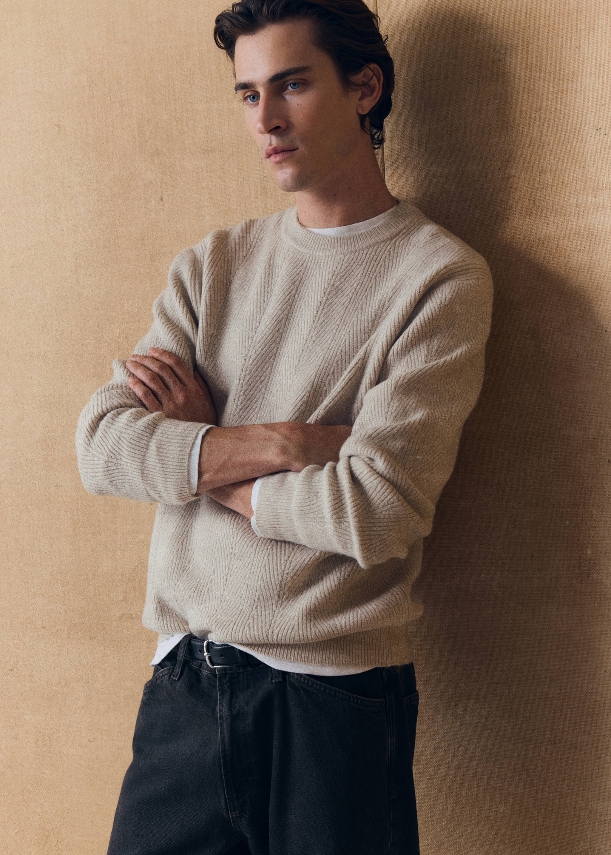 Beige crew neck knit jersey with ribbed chevron pattern over a white t-shirt.