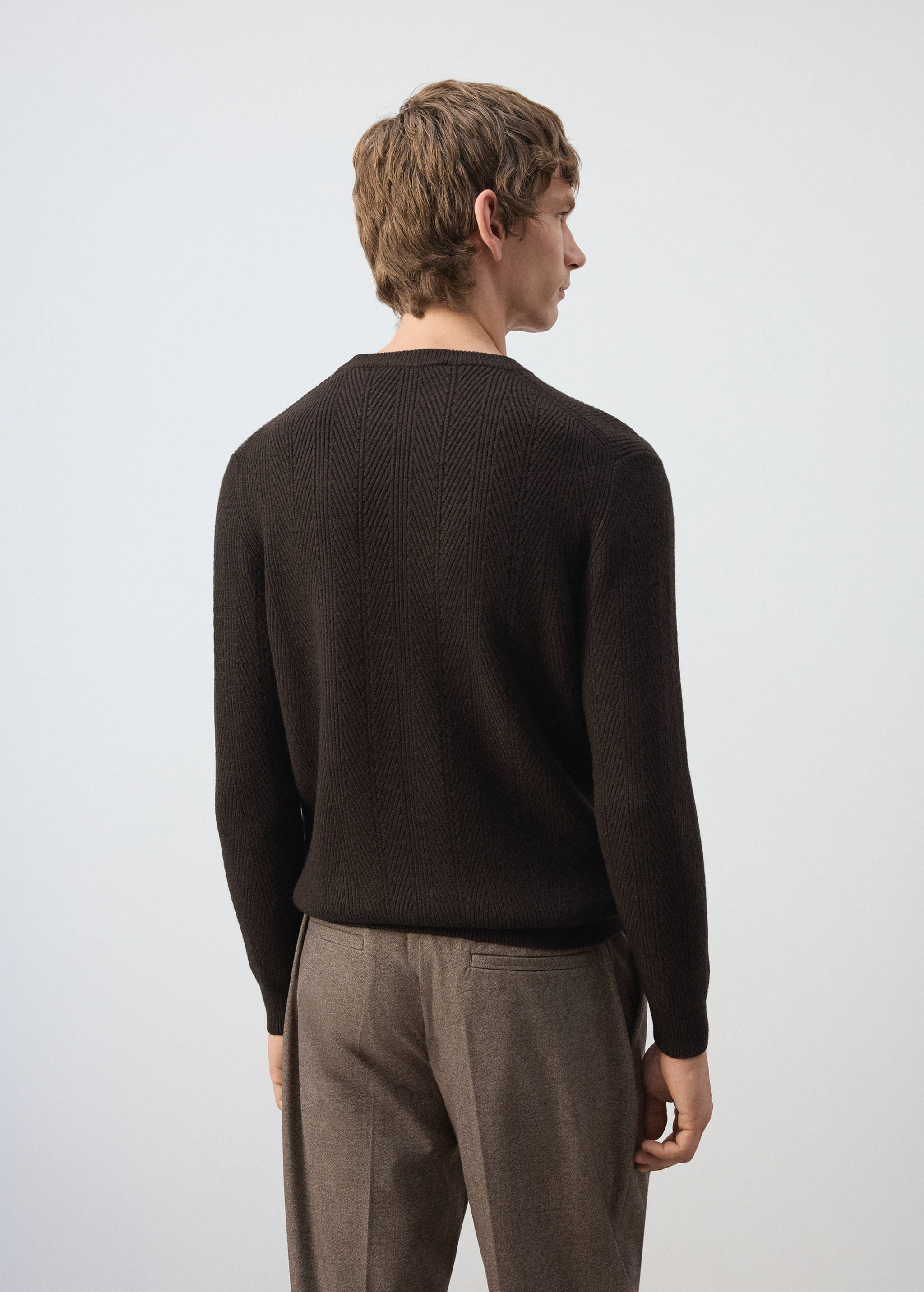 Back view of a dark brown knitted jumper with a crew neck.