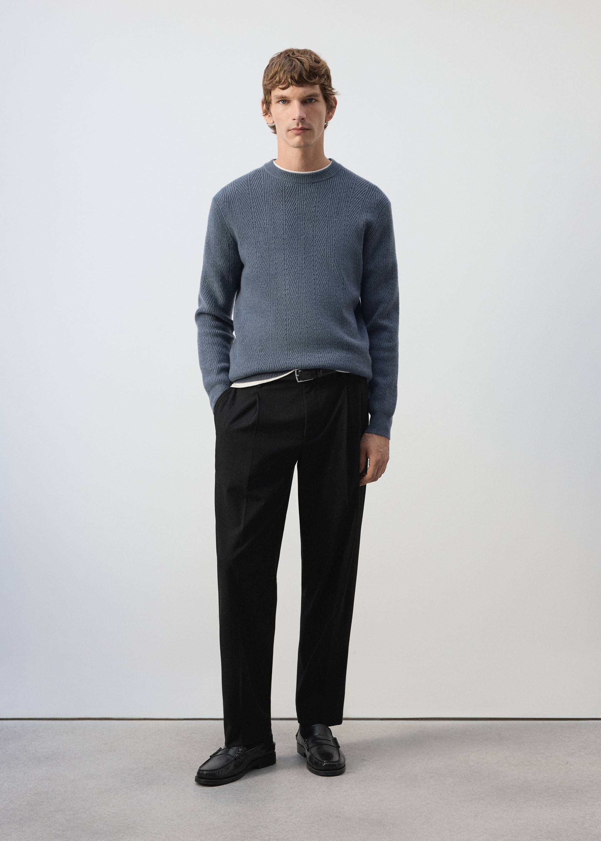 Blue textured crew neck jersey worn with black trousers