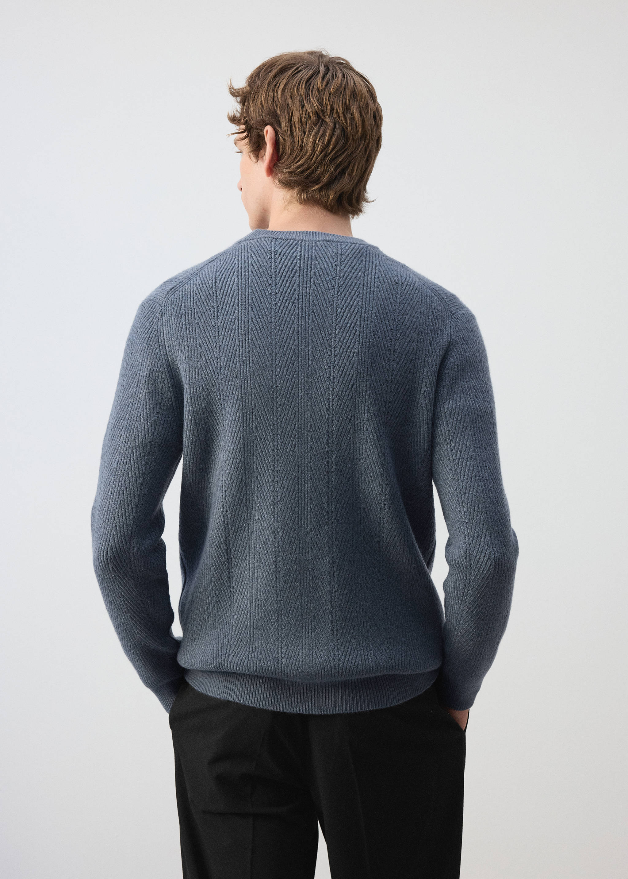 Back view of a textured blue crew neck jersey with long sleeves.
