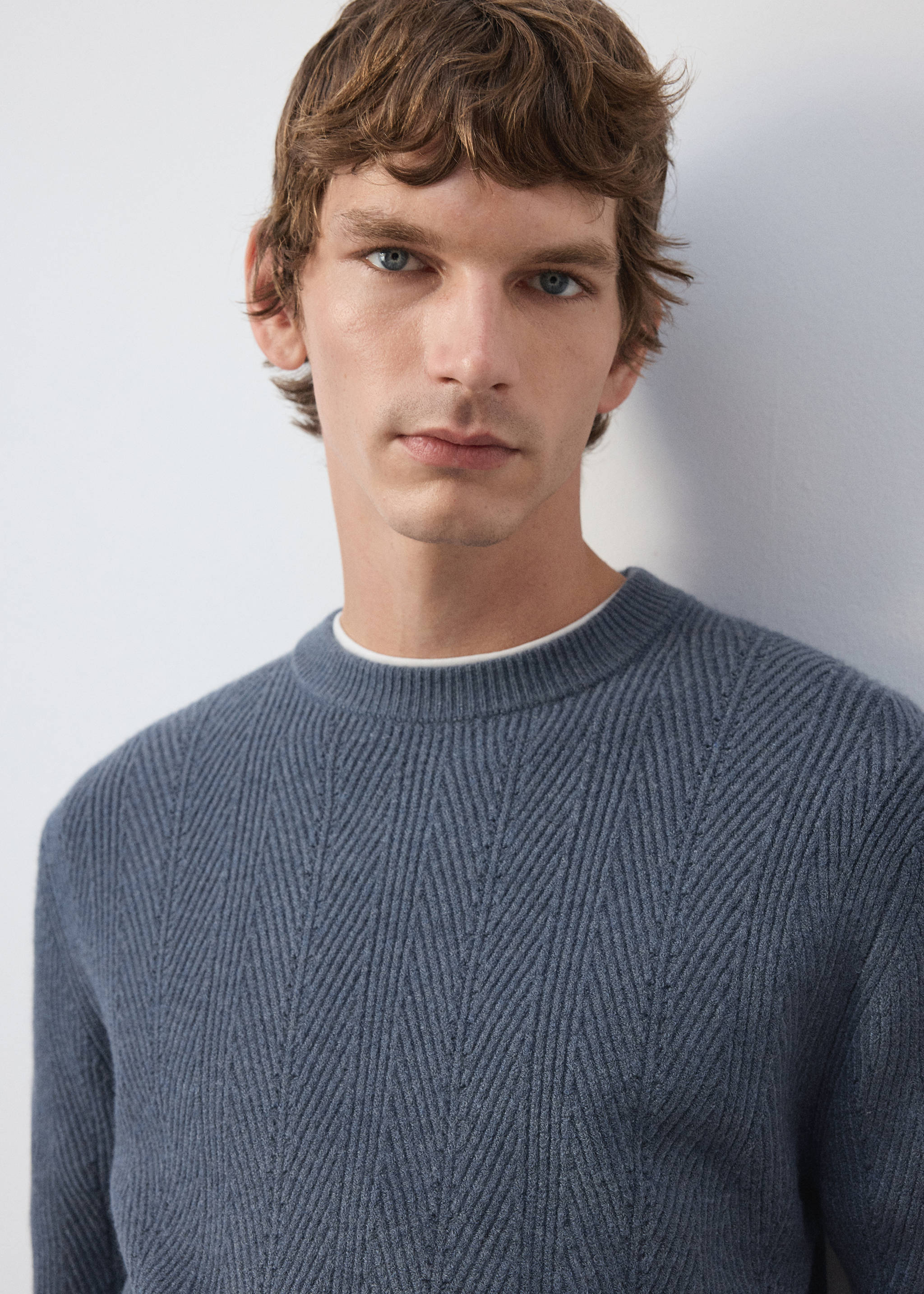 Slate blue knit jersey with a textured chevron pattern and crew neck.
