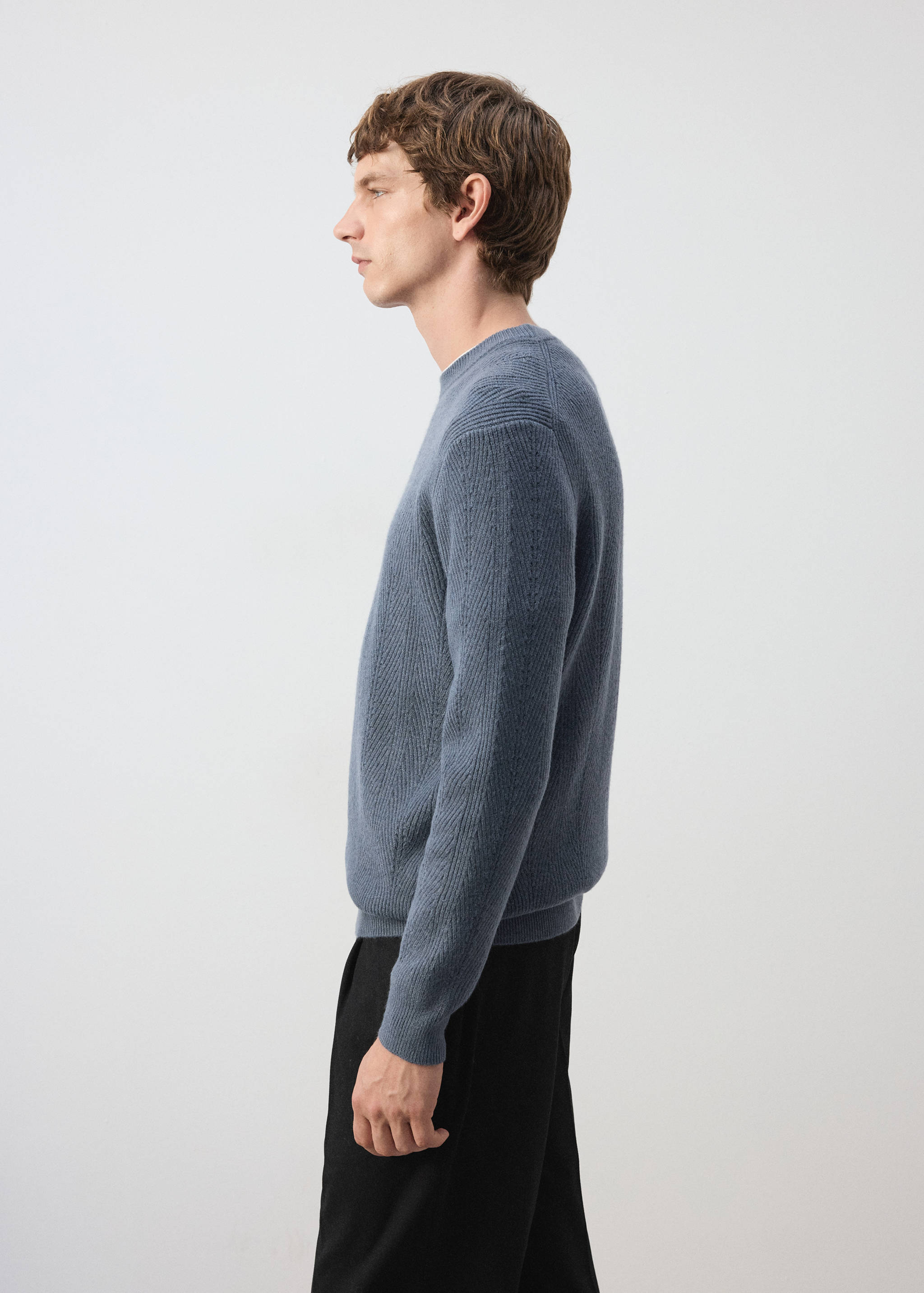 Blue knitted crew-neck jersey in a textured ribbed pattern.