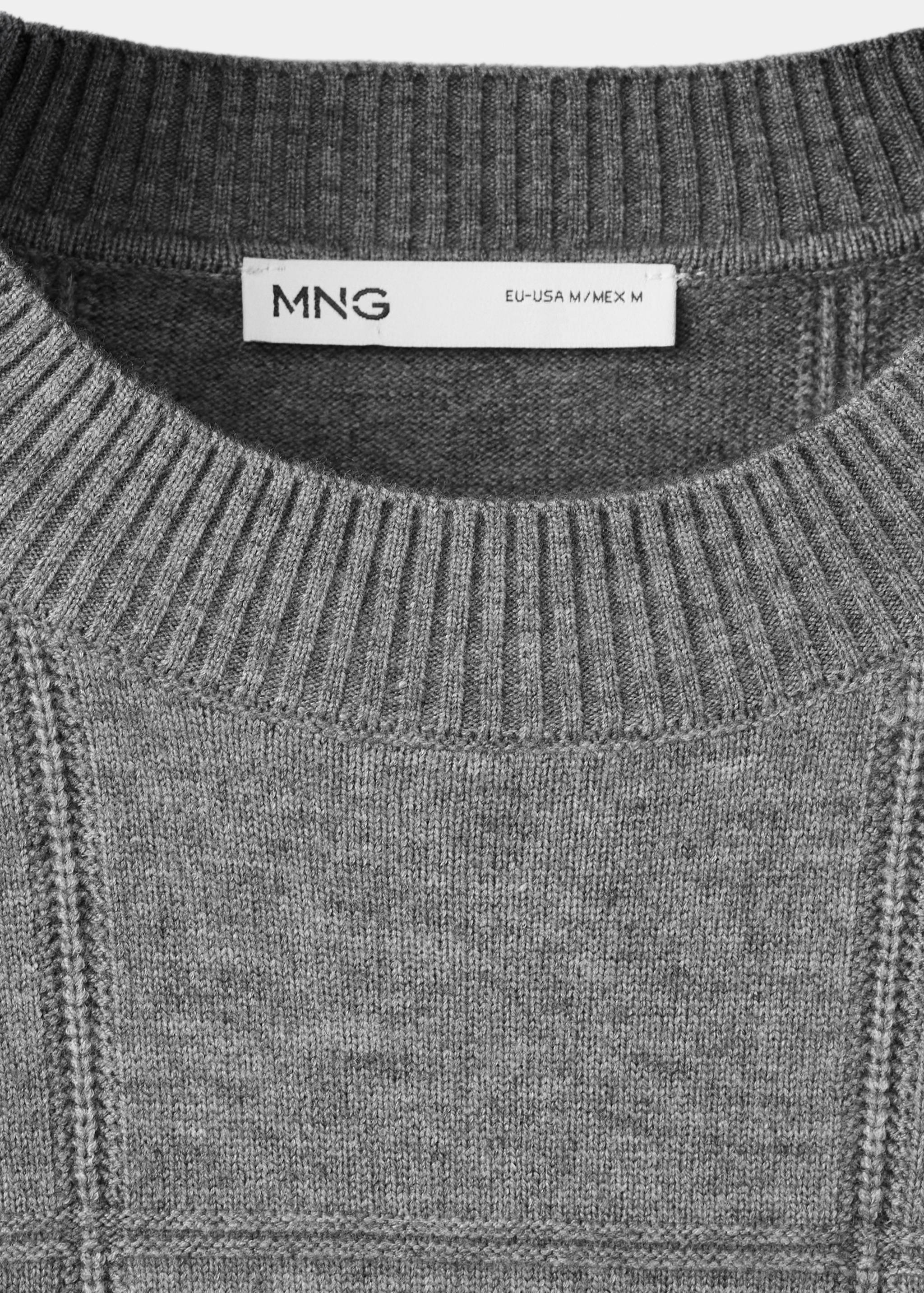 Close-up of a grey knit jersey featuring a ribbed crew neckline.