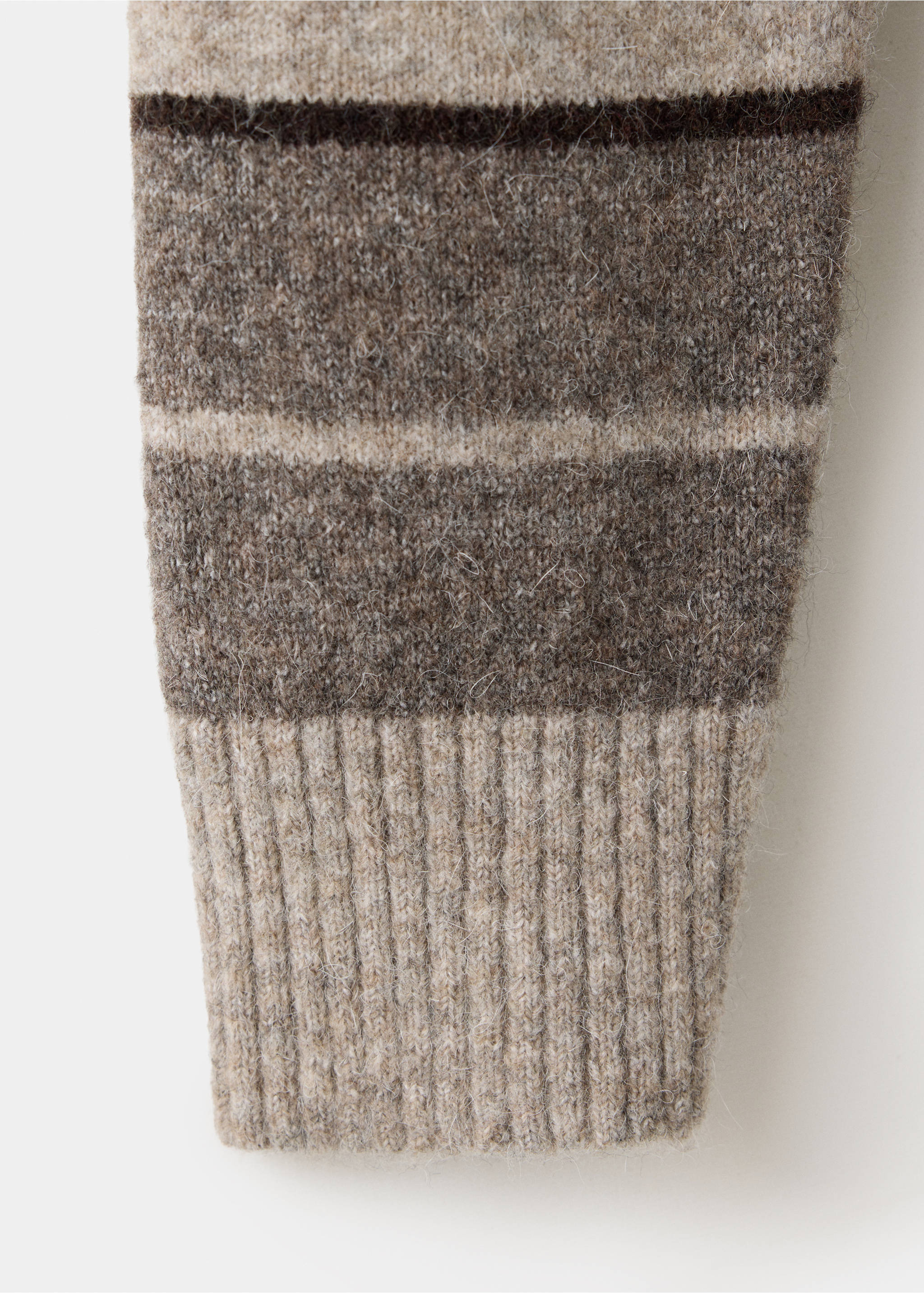Close-up of a fuzzy striped knit jumper fabric and ribbed cuff., Medium Brown. Ref: 37027918-00.