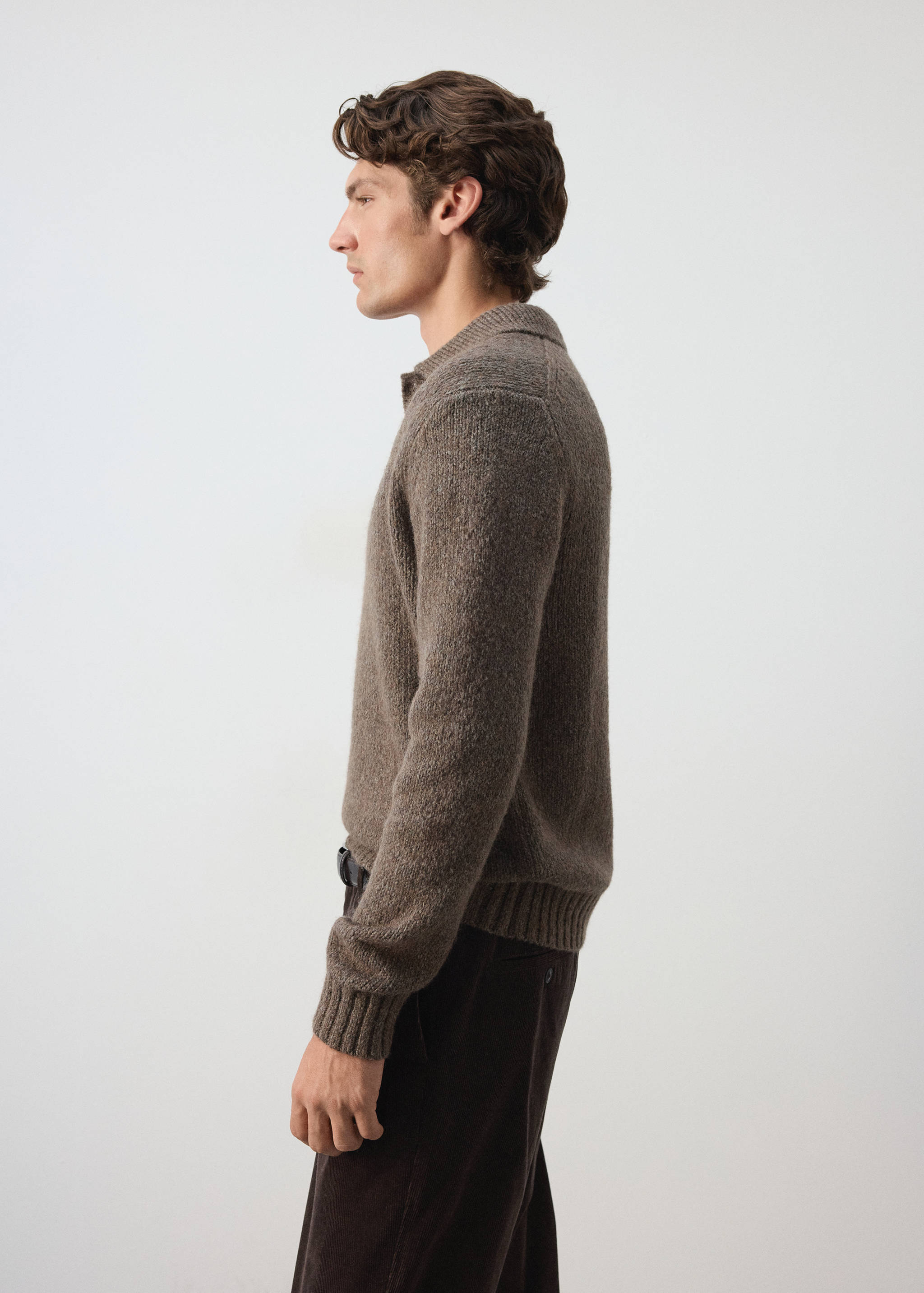 Brown knitted polo shirt with long sleeves and a ribbed collar.