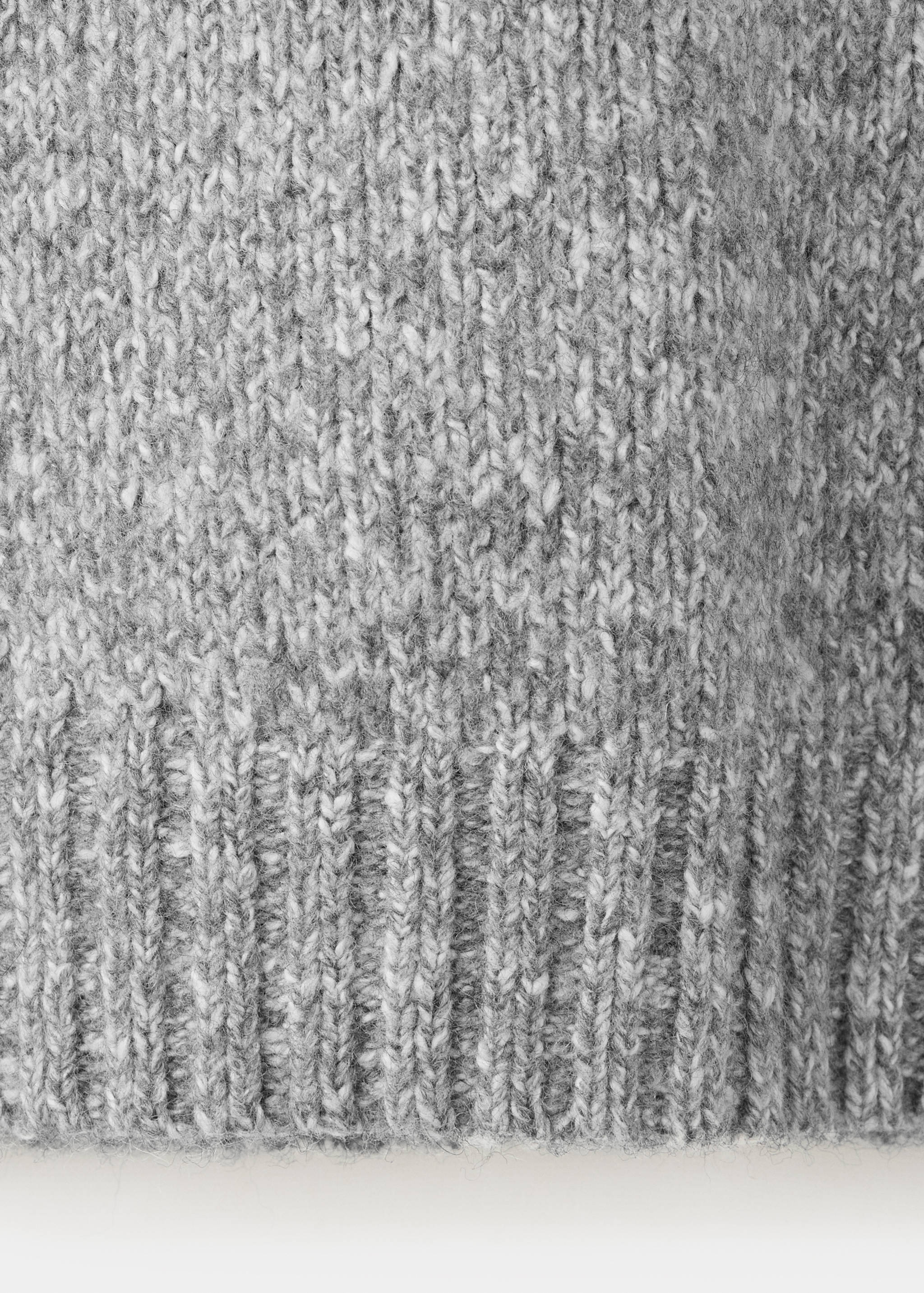 Close-up of the grey knit fabric on a men's polo.