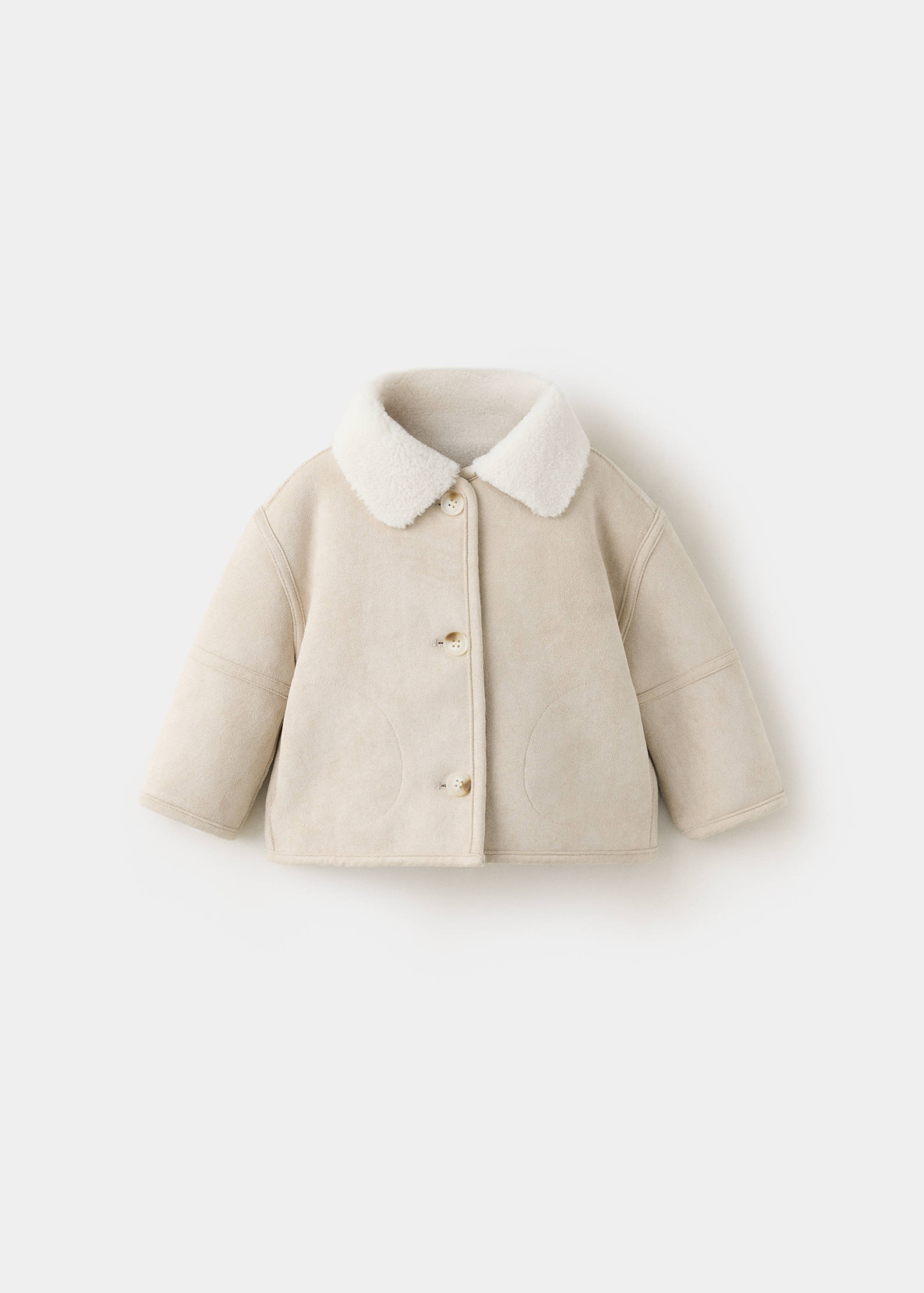 Cream children's faux-shearling coat with a pointed collar and front buttons.