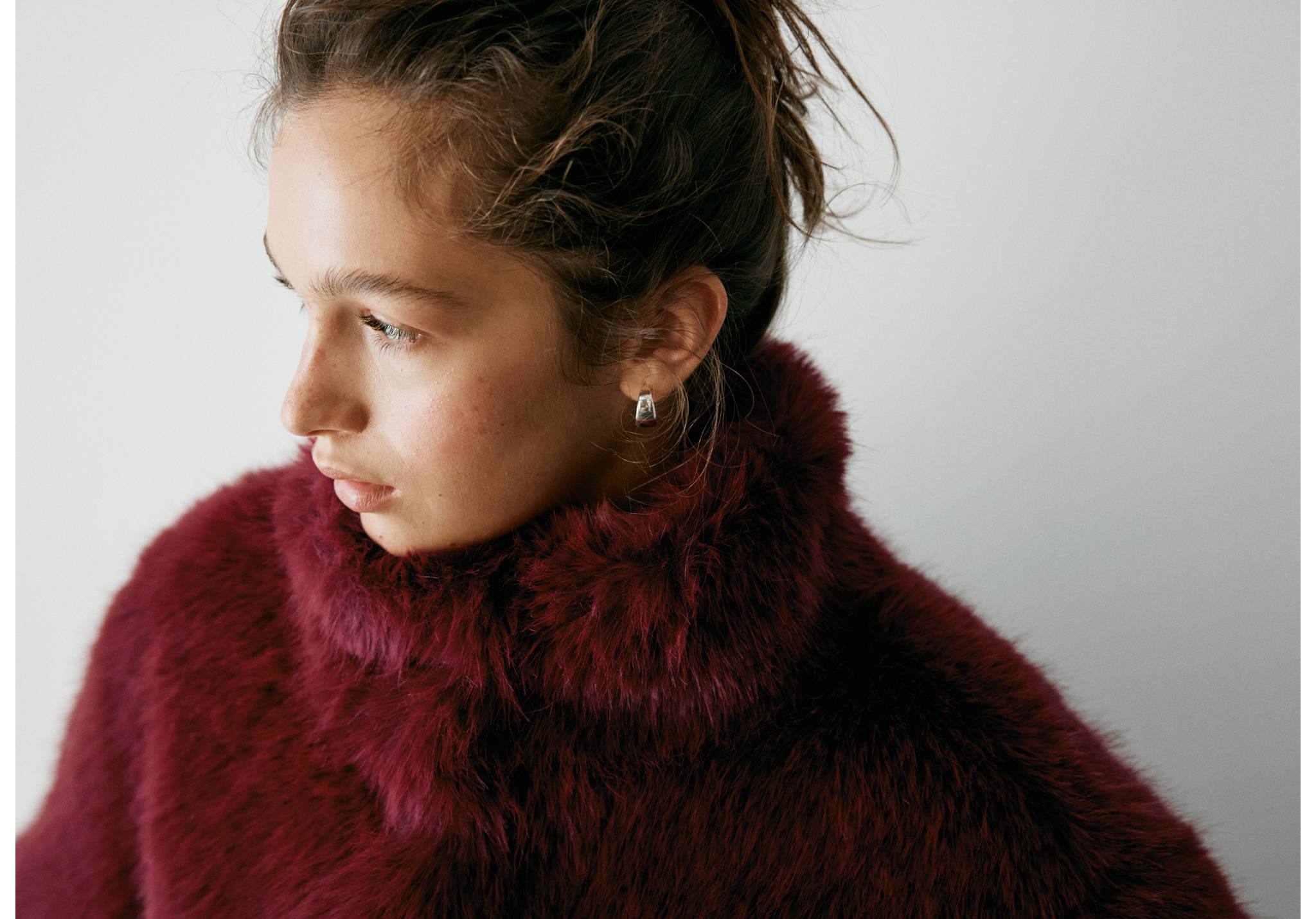 Burgundy faux-fur coat with a high collar.