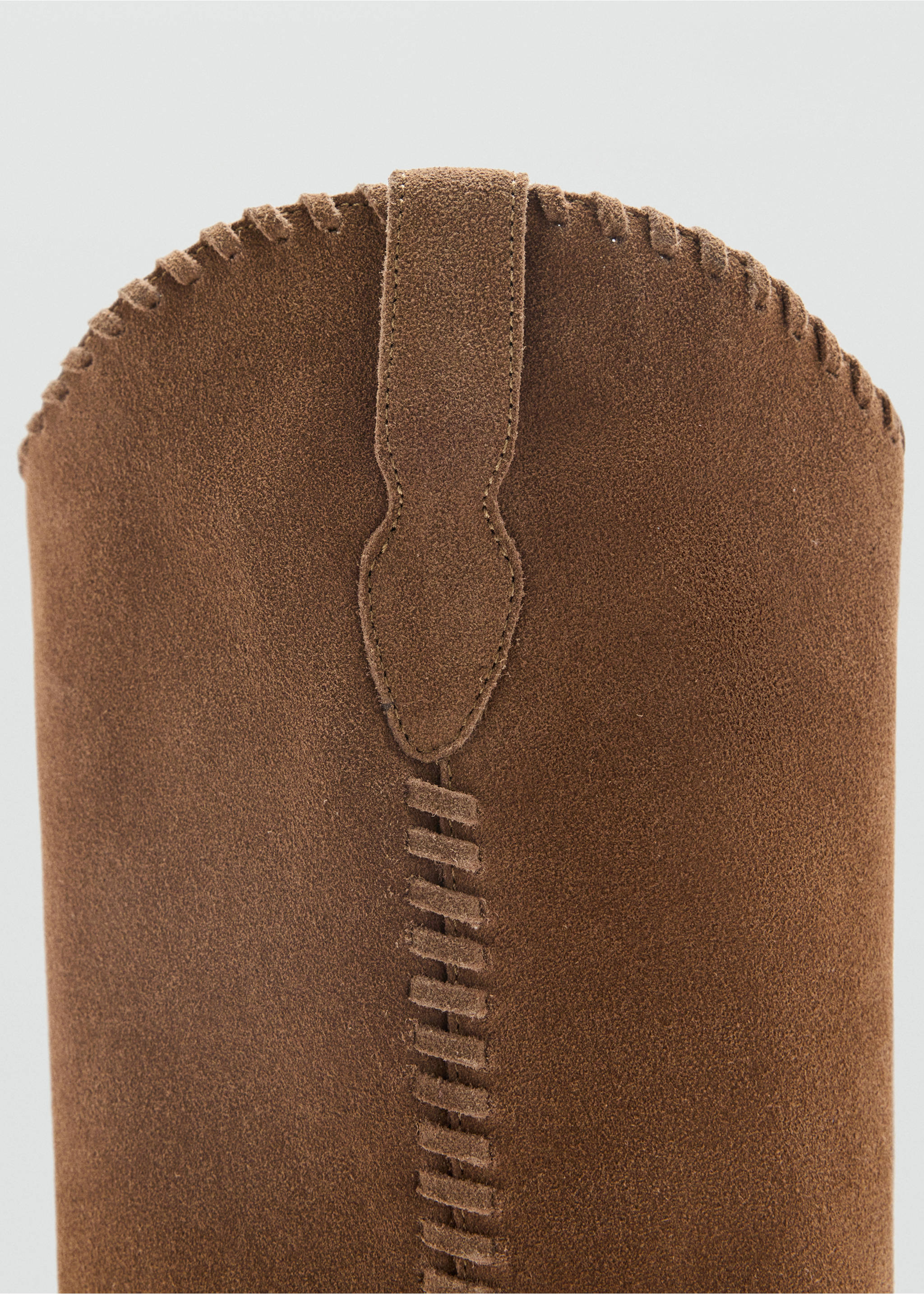 Close-up of brown suede boot showing decorative whipstitch and pull tab detail., Medium Brown. Ref: 37027936-00.