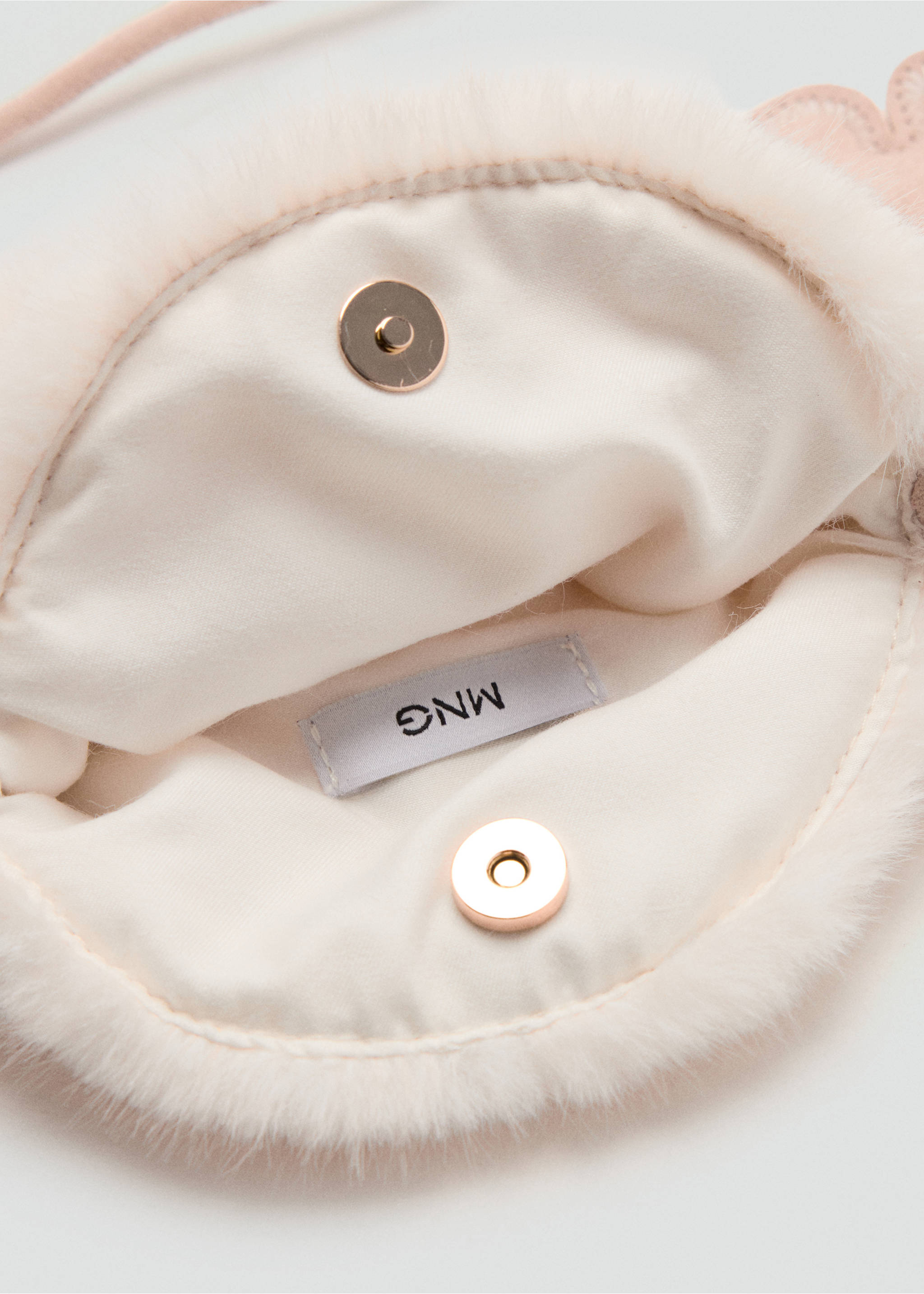 Close-up of the interior lining and magnetic snap closure of a pink mini bag., Ecru. Ref: 37027937-00.