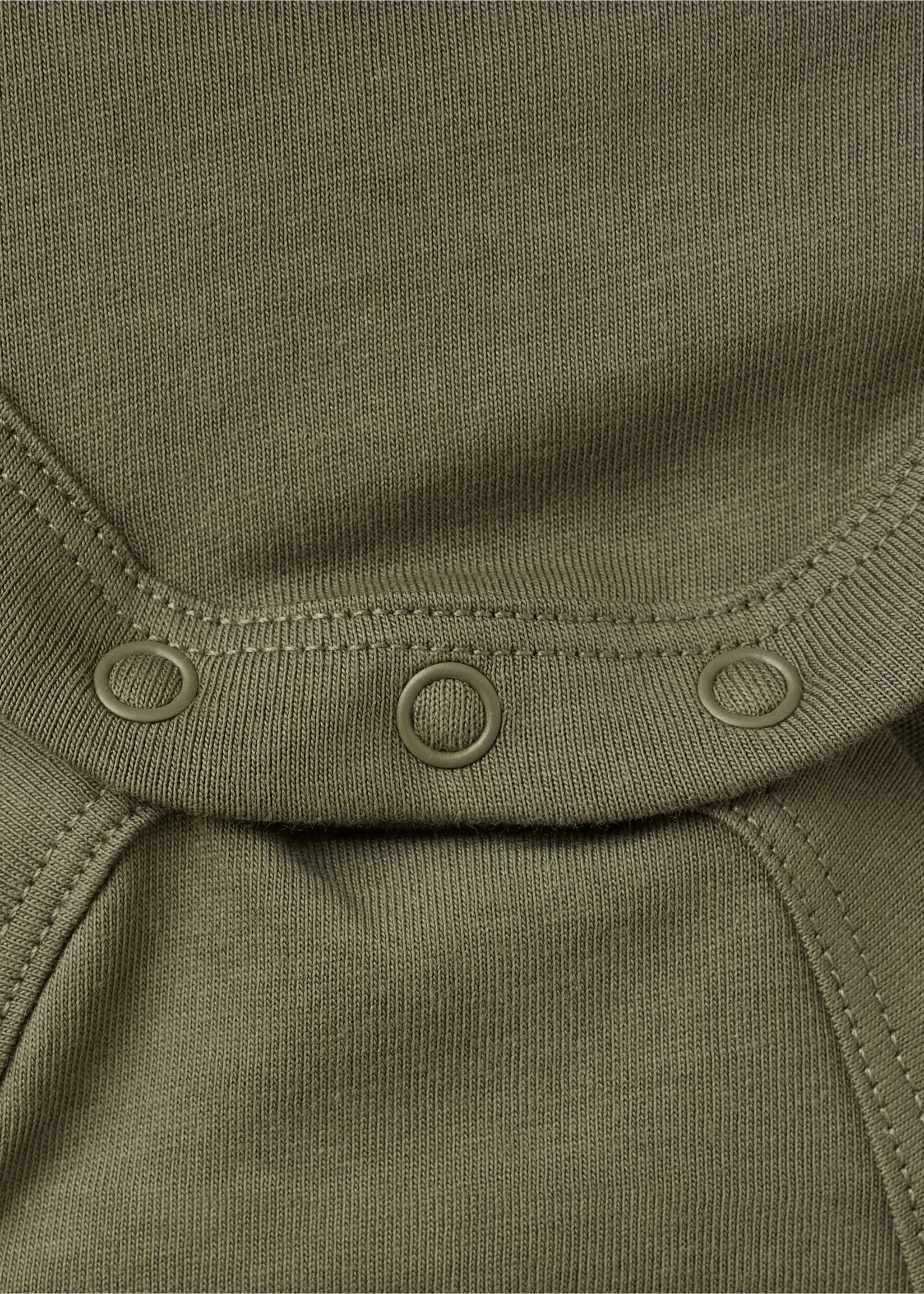 Close-up of an olive green baby body showing the fabric texture and snap buttons., Dark Green. Ref: 37027938-00.