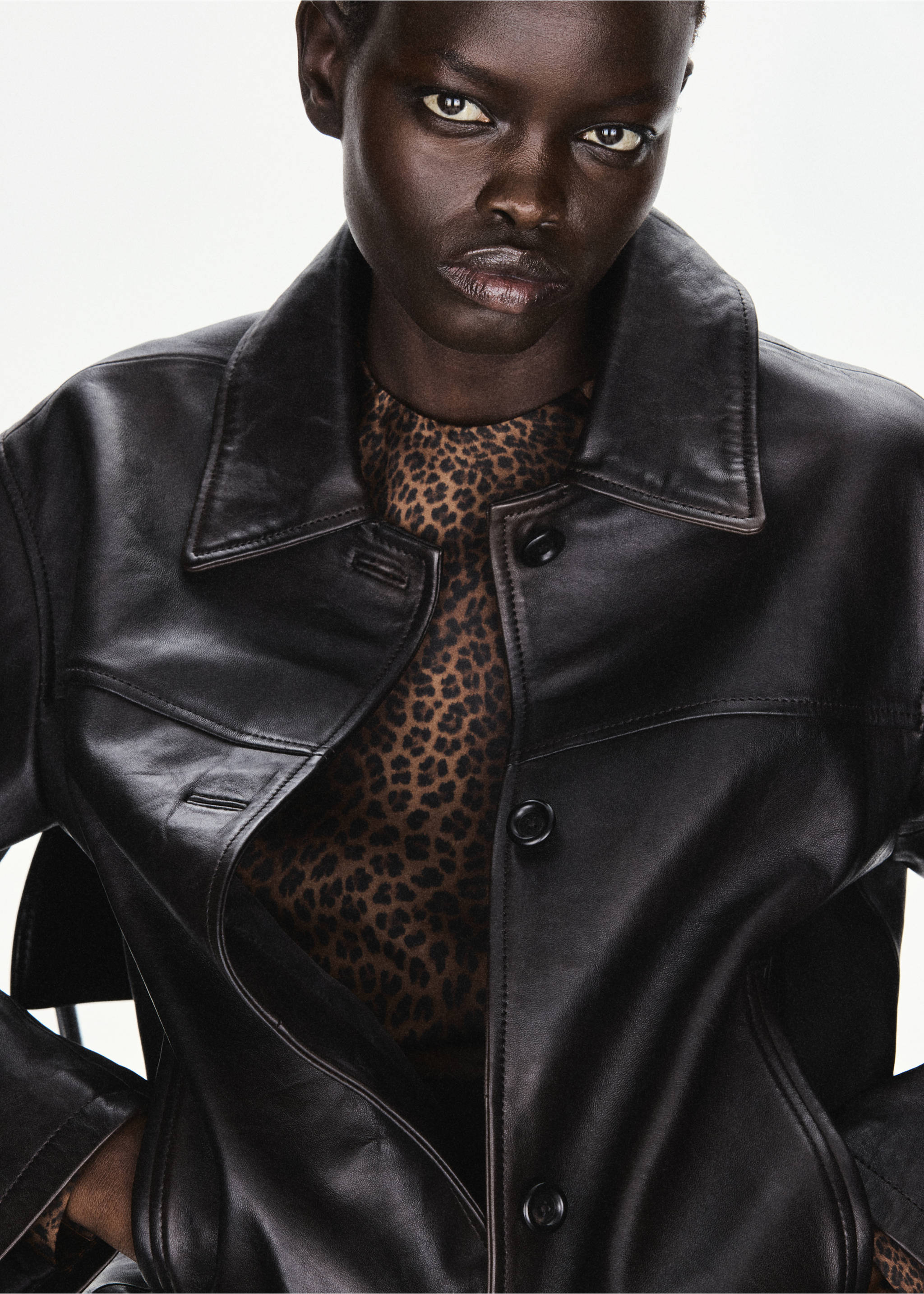 Leopard-print blouse worn under a dark leather jacket., Brown. Ref: 37027940-00.
