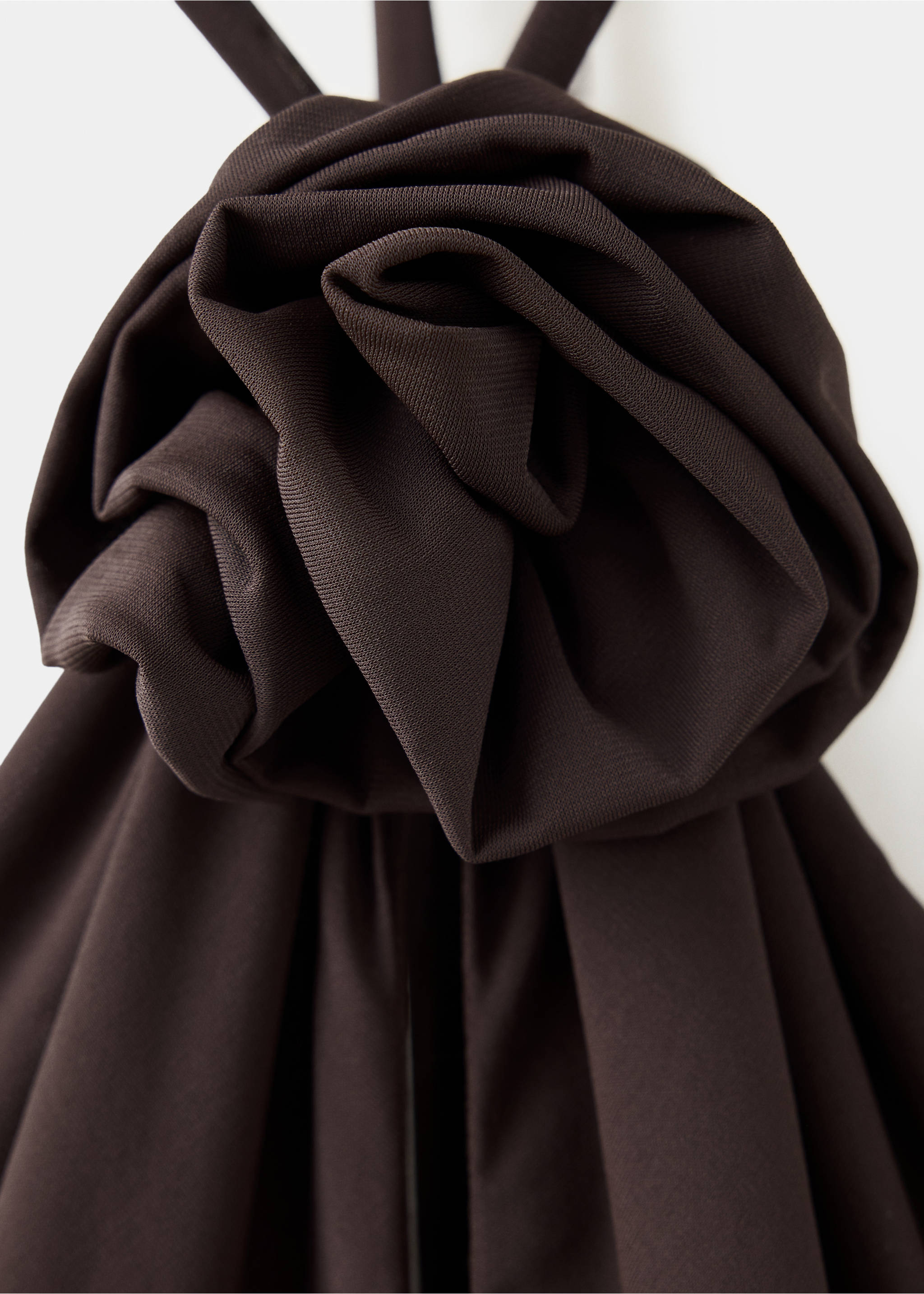 Dark brown dress detail featuring a large sculptural fabric rosette., Brown. Ref: 37027941-00.