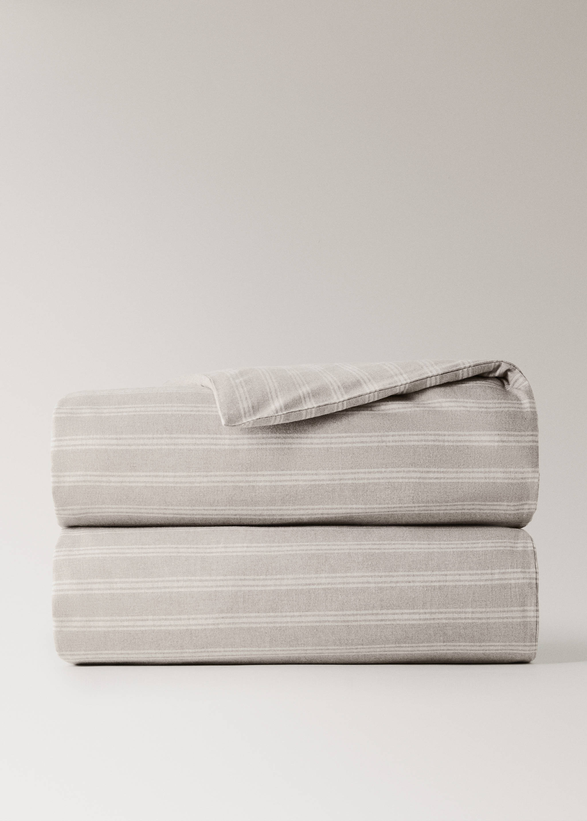 Neutral beige duvet cover featuring a soft white striped pattern, neatly folded.