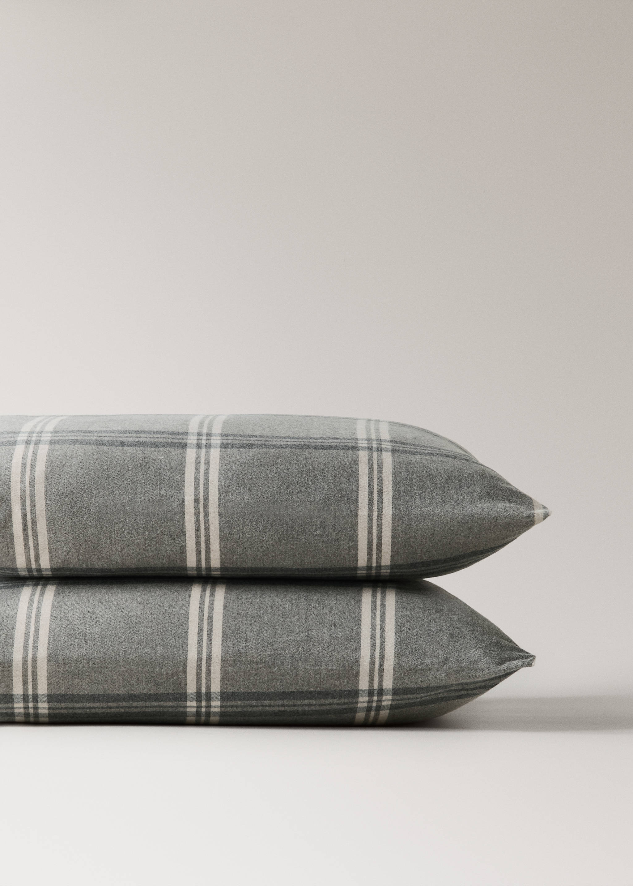 Grey checked pillowcase in a soft flannel-textured fabric.