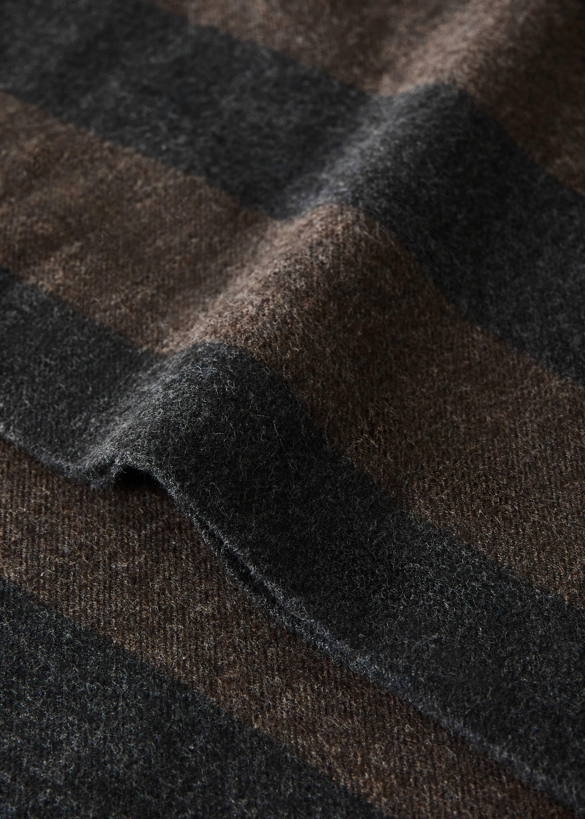 Close-up of a dark grey and brown striped pillow cover fabric.