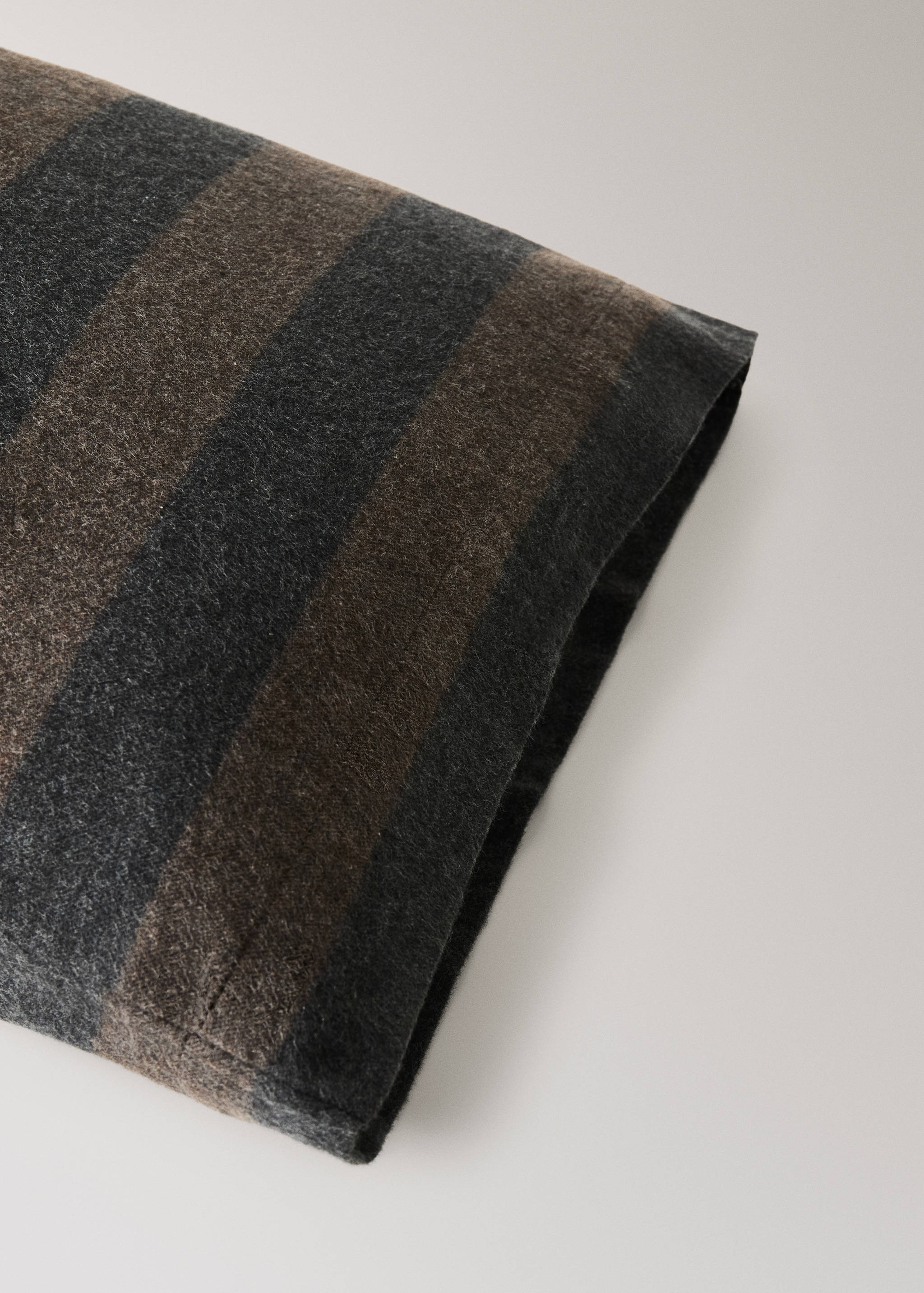 Striped pillowcase in dark grey and brown.