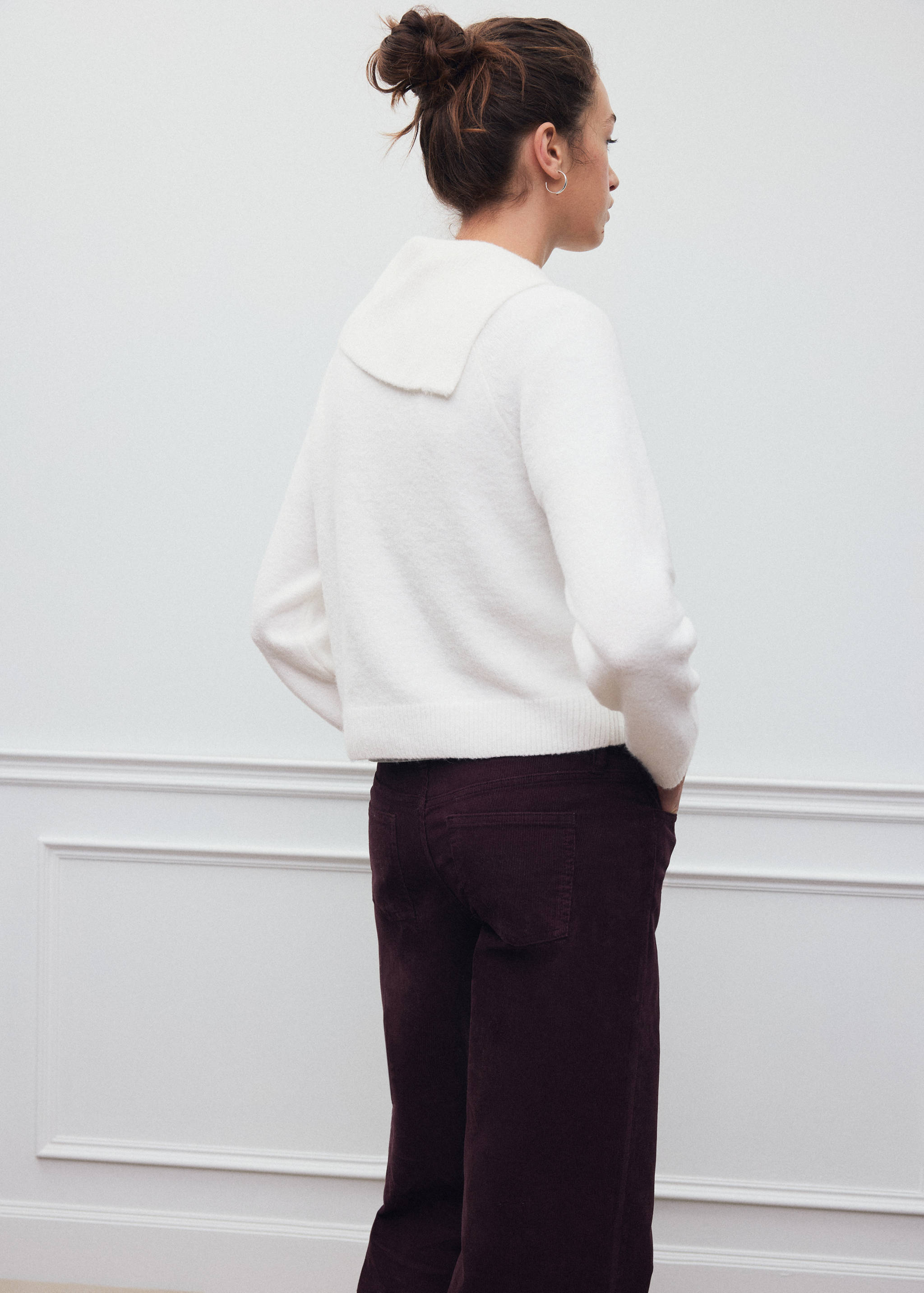 White knit jersey with folded collar, shown from the back.