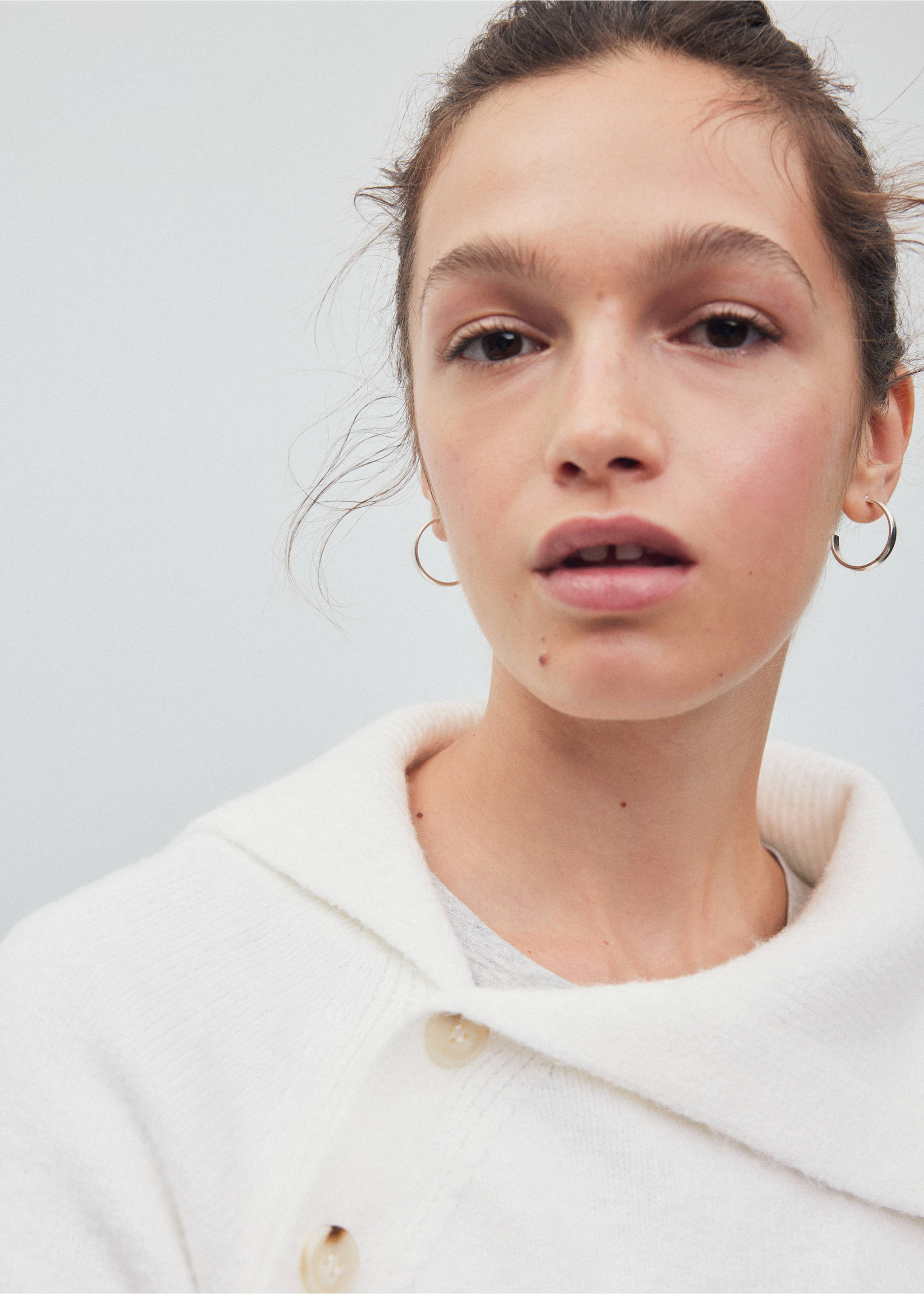 Close-up of a white knitted jumper with a shawl collar and button details., Beige. Ref: 37028282-00.