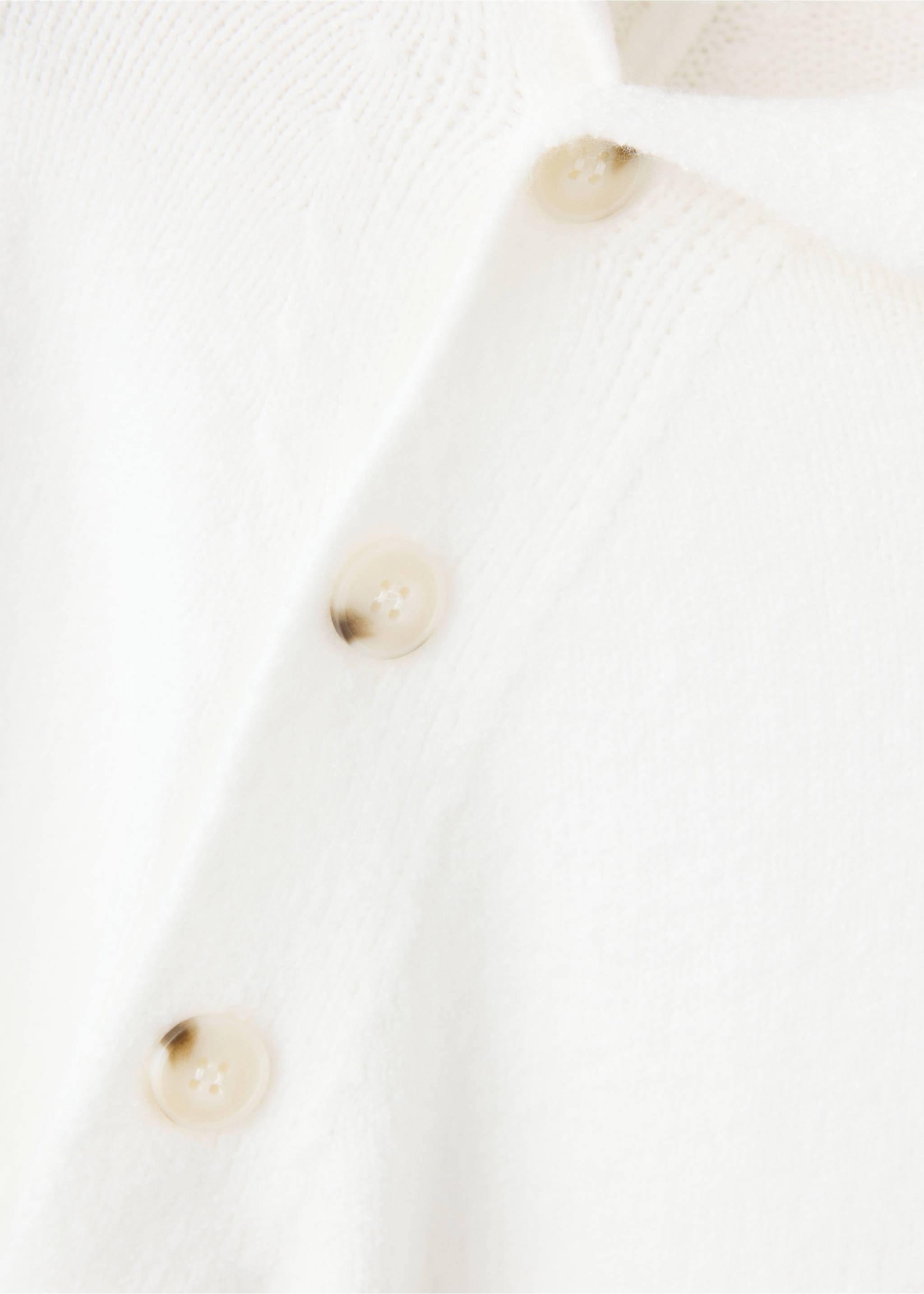 Close-up of white knitted jumper detail with tortoiseshell buttons., Beige. Ref: 37028282-00.