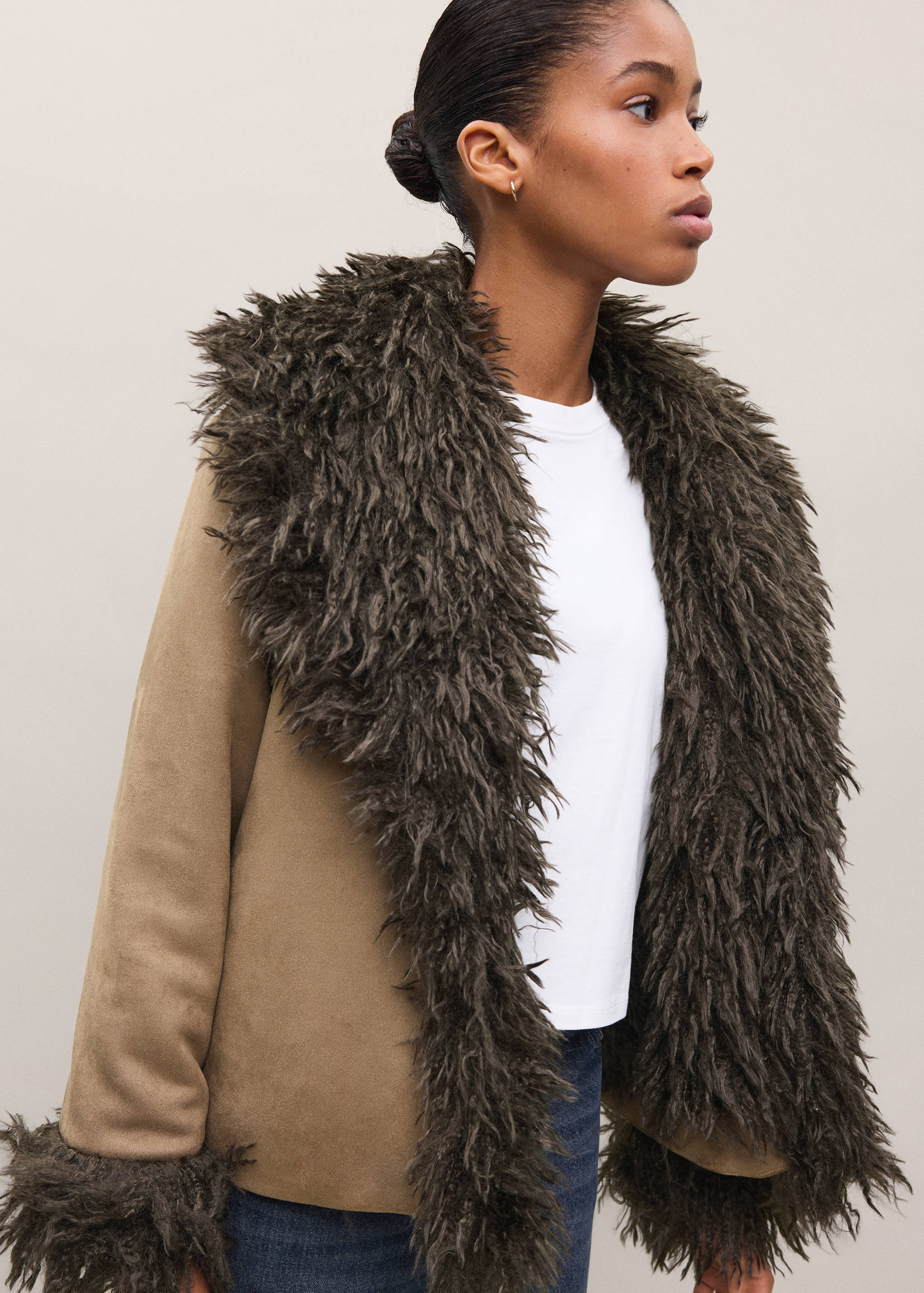 Brown coat with shaggy dark green faux-fur collar.
