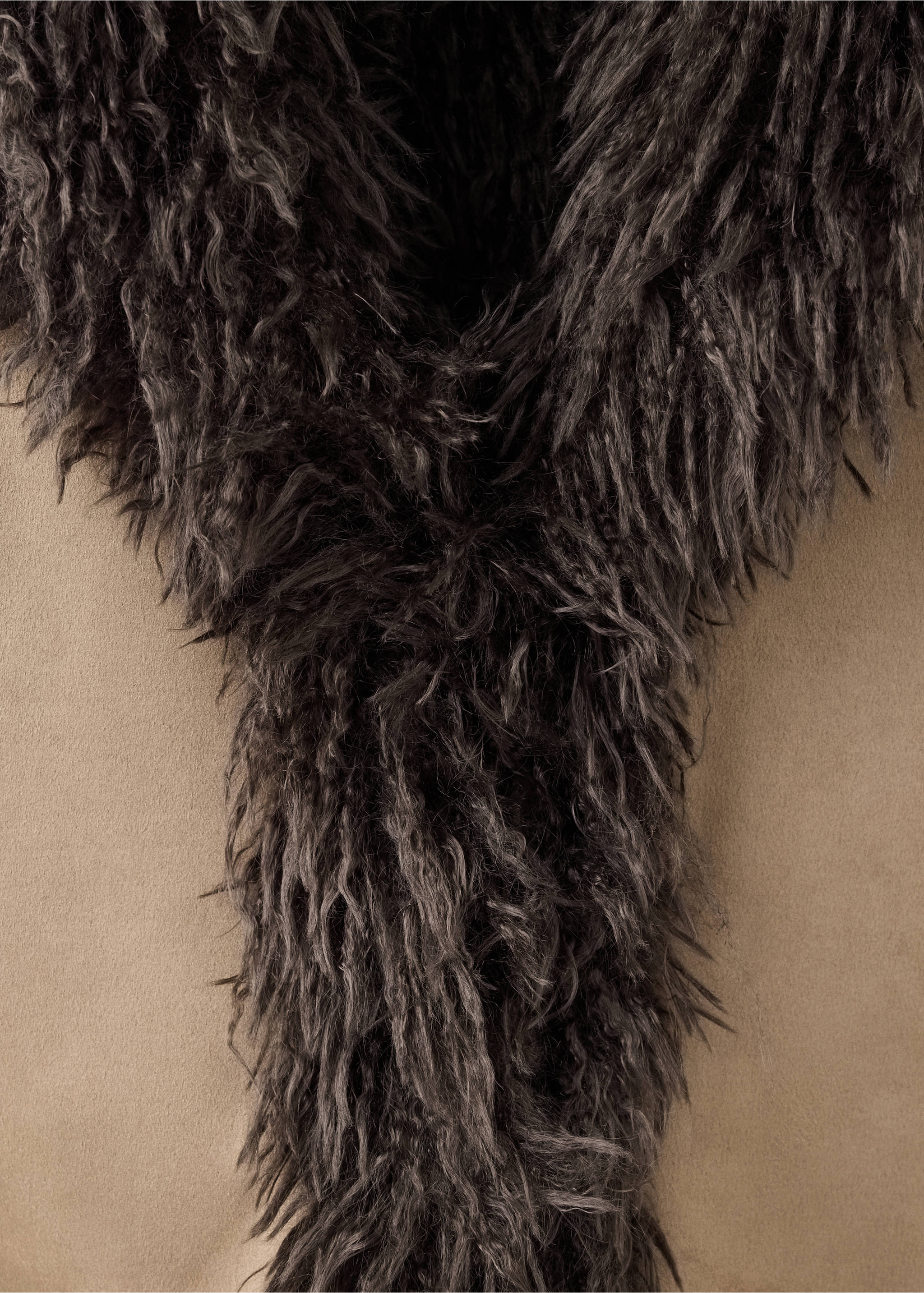 Close-up of a coat showing a dark grey faux-fur collar on a beige fabric., Medium Brown. Ref: 37028285-00.