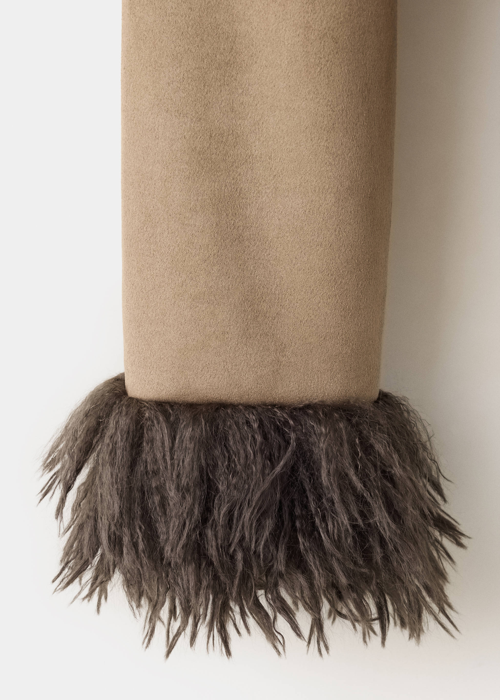 Camel coat sleeve detail with a dark grey faux-fur cuff.
