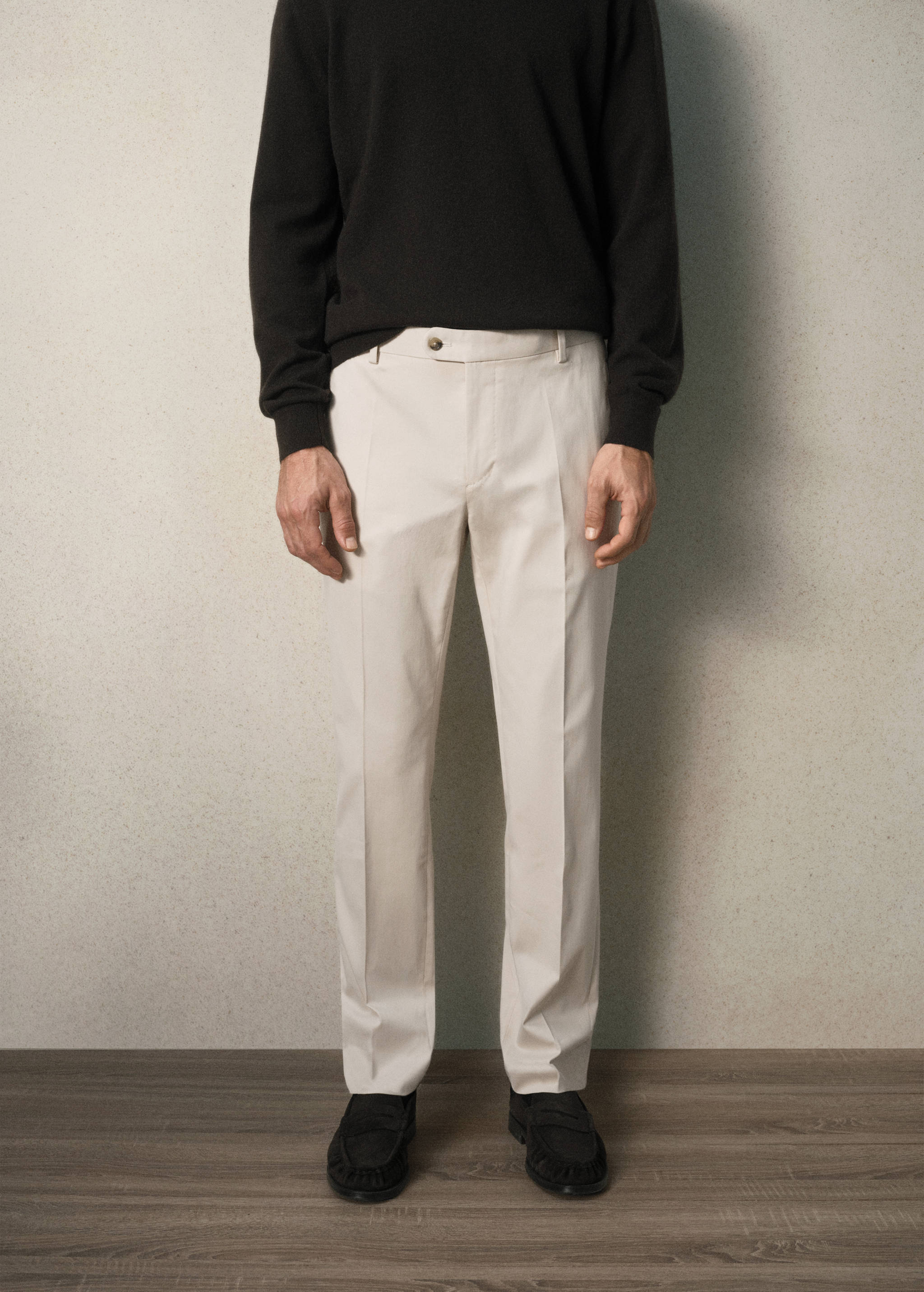 Off-white tailored trousers with a straight-leg fit and pressed creases.