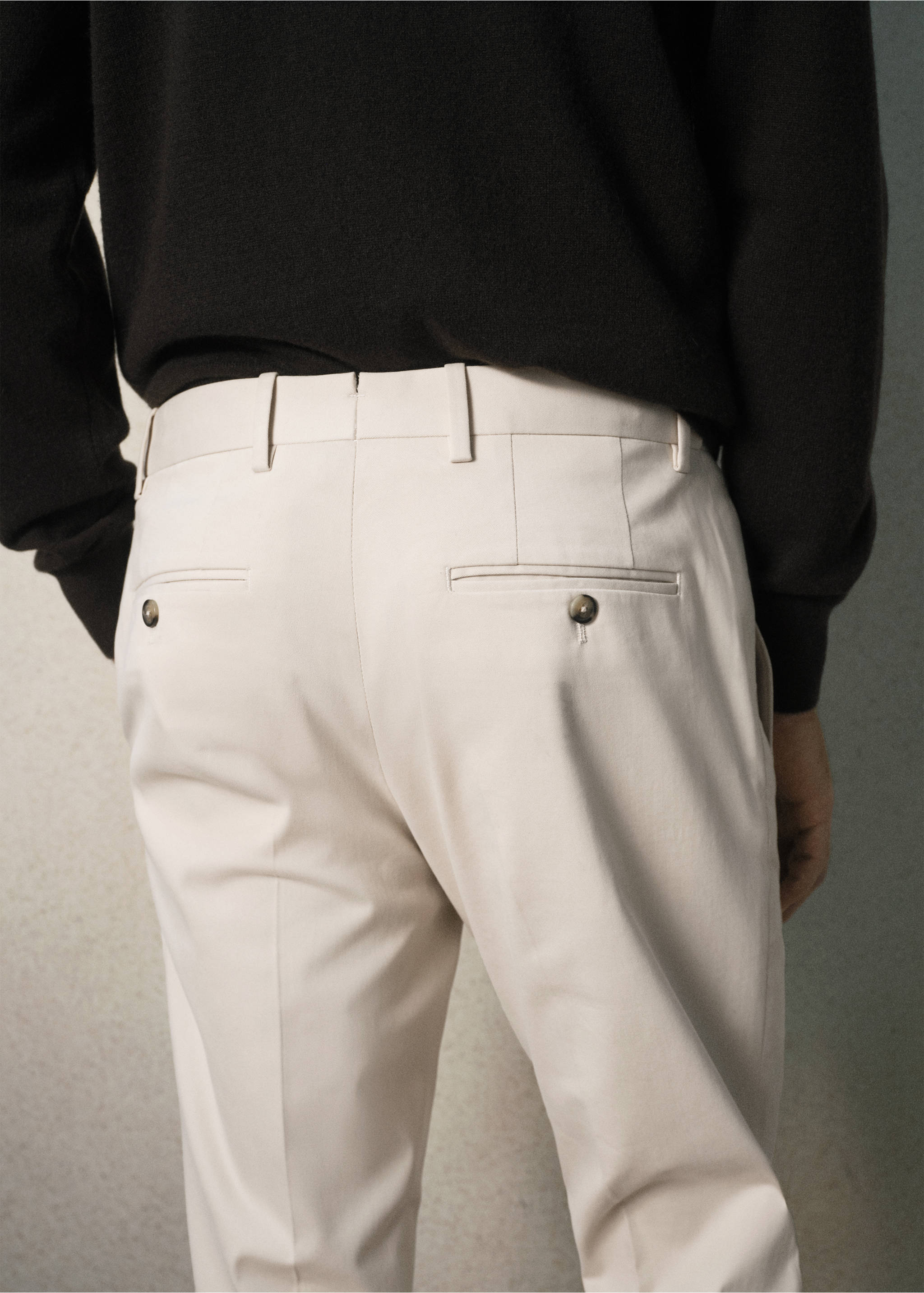 Back view of light beige trousers featuring belt loops and buttoned rear pockets., Beige. Ref: 37028631-00.