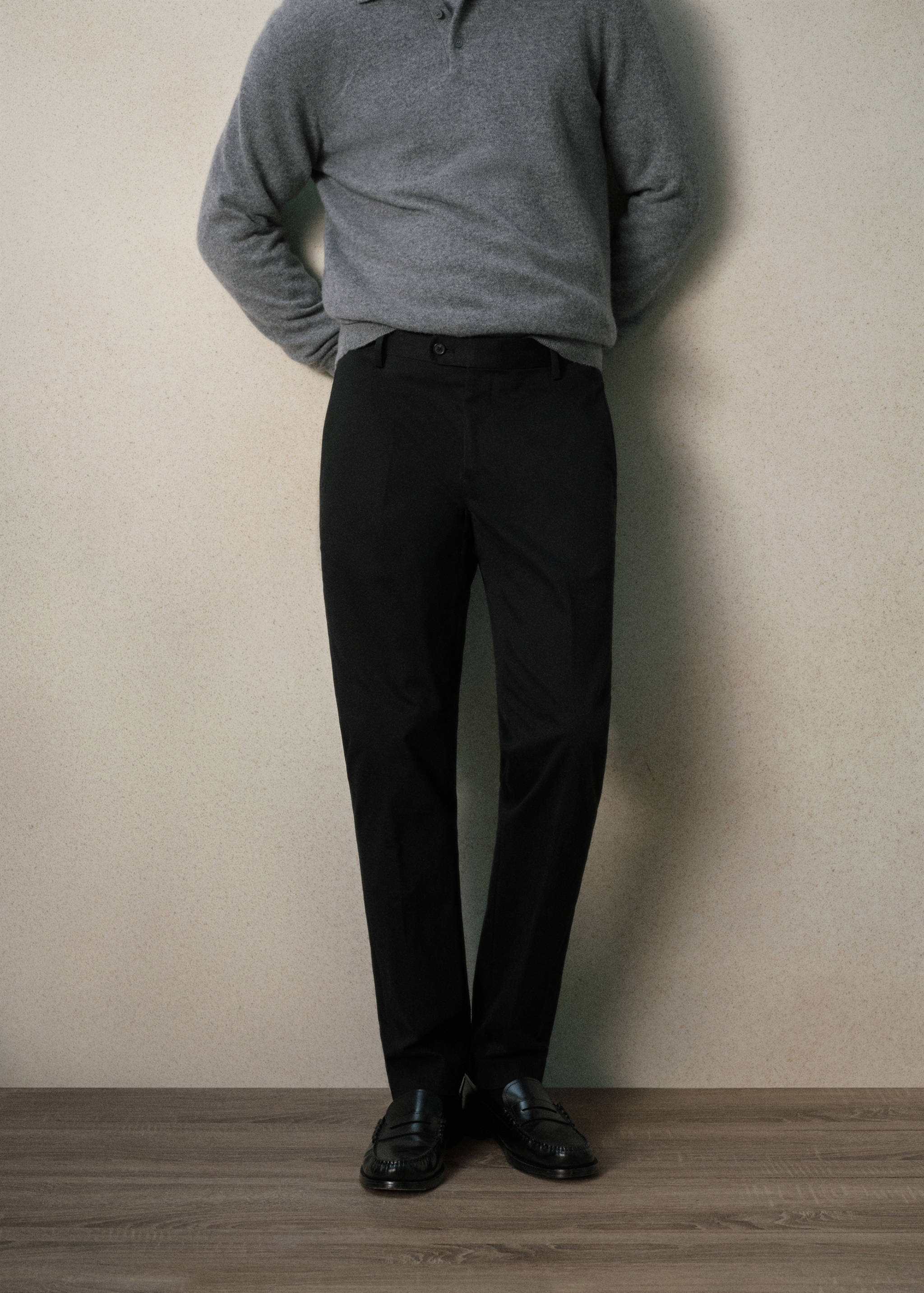Black straight-leg trousers with a structured waistband and belt loops.