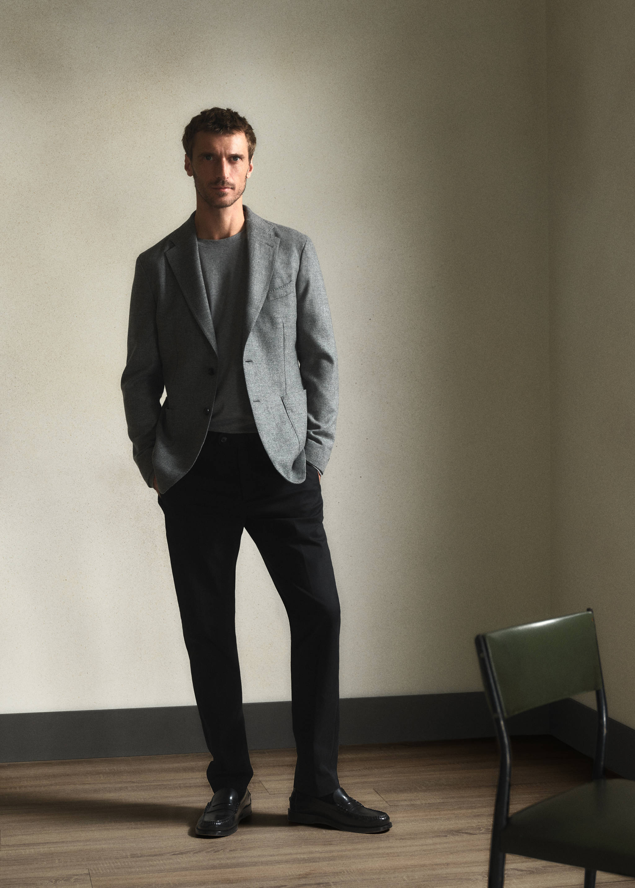 Black trousers worn by a model in a grey blazer and jumper.