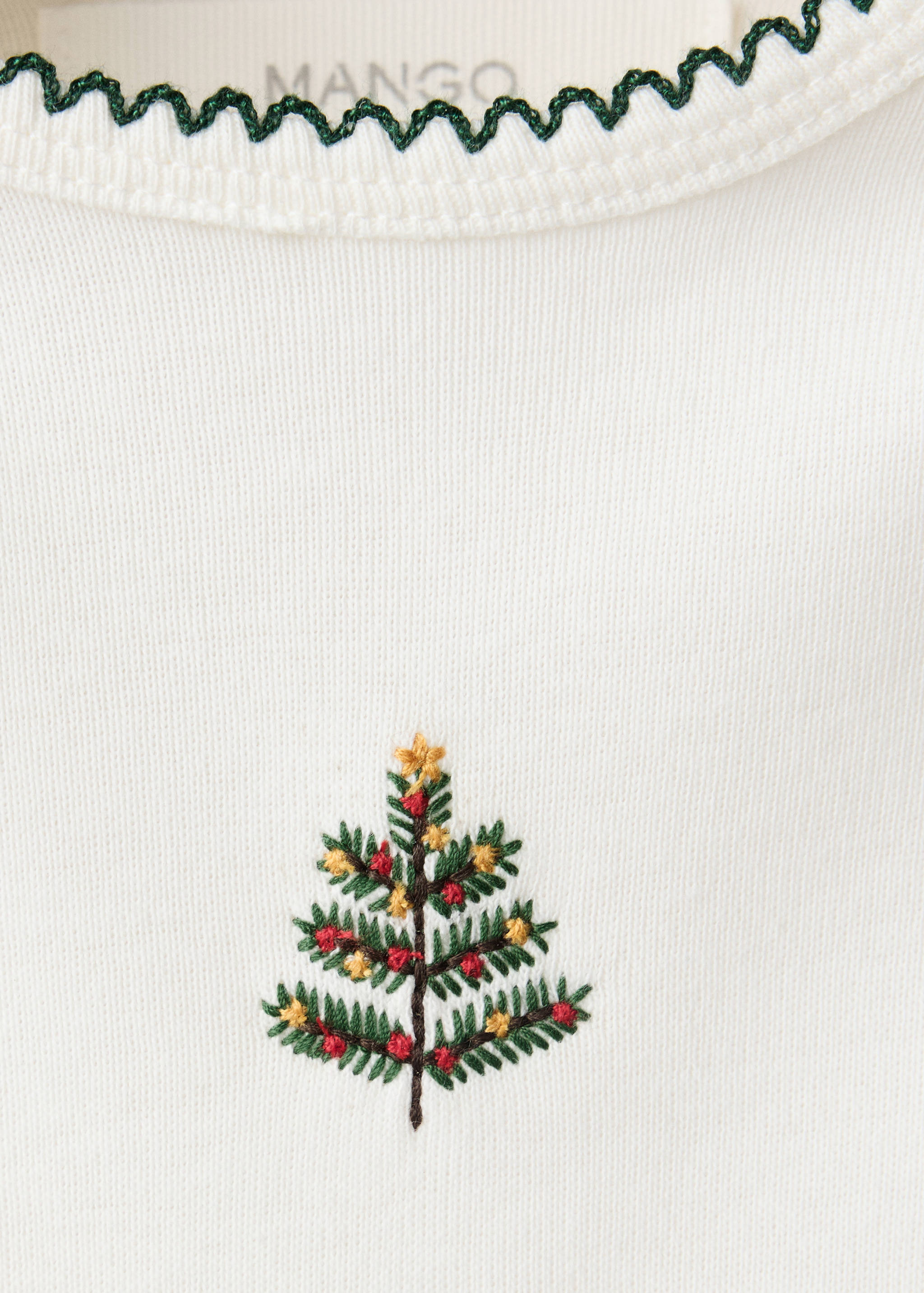 Off-white baby body with green scalloped collar and Christmas tree embroidery detail.