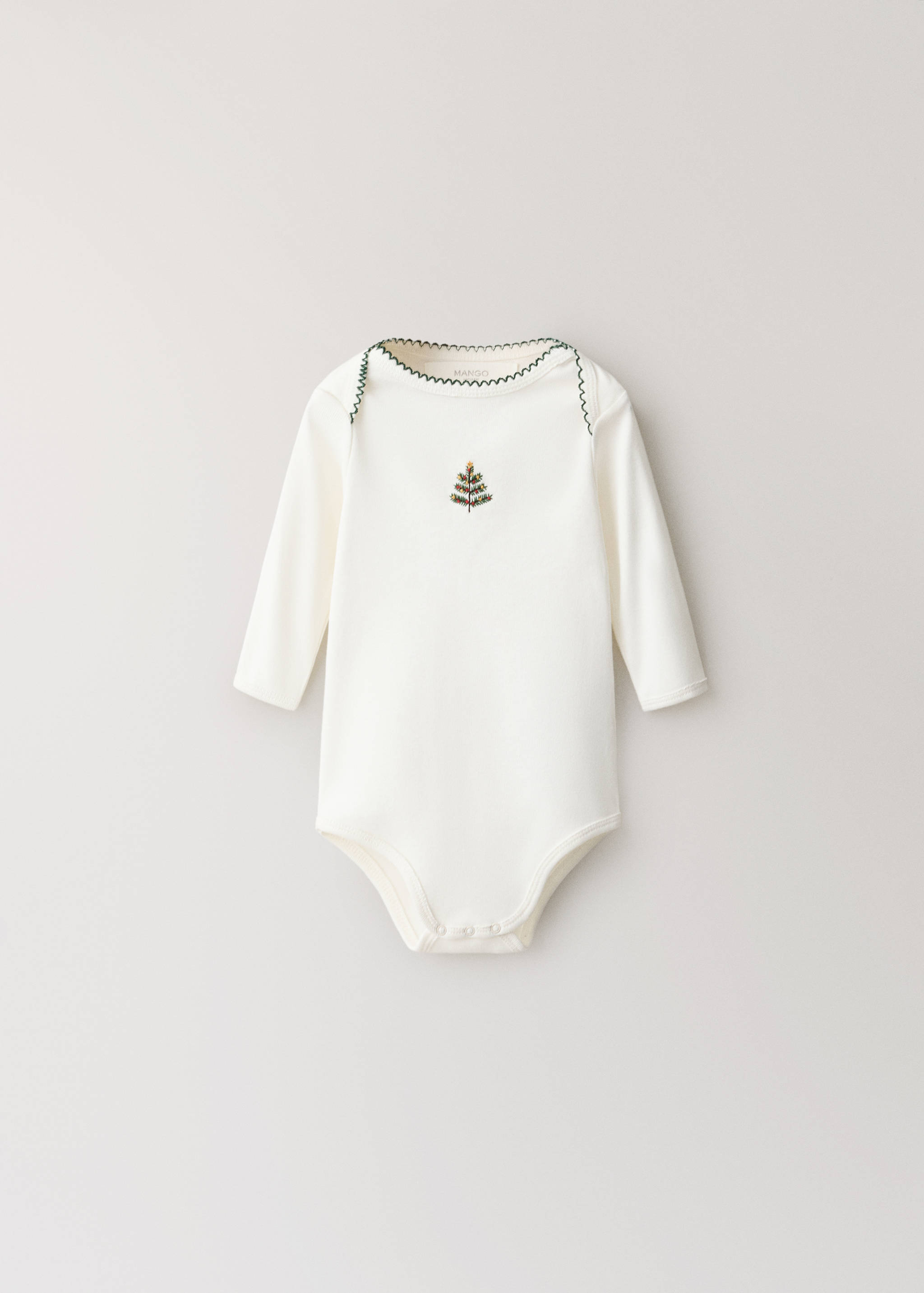 Off-white baby body with long sleeves, green trim, and Christmas tree embroidery.