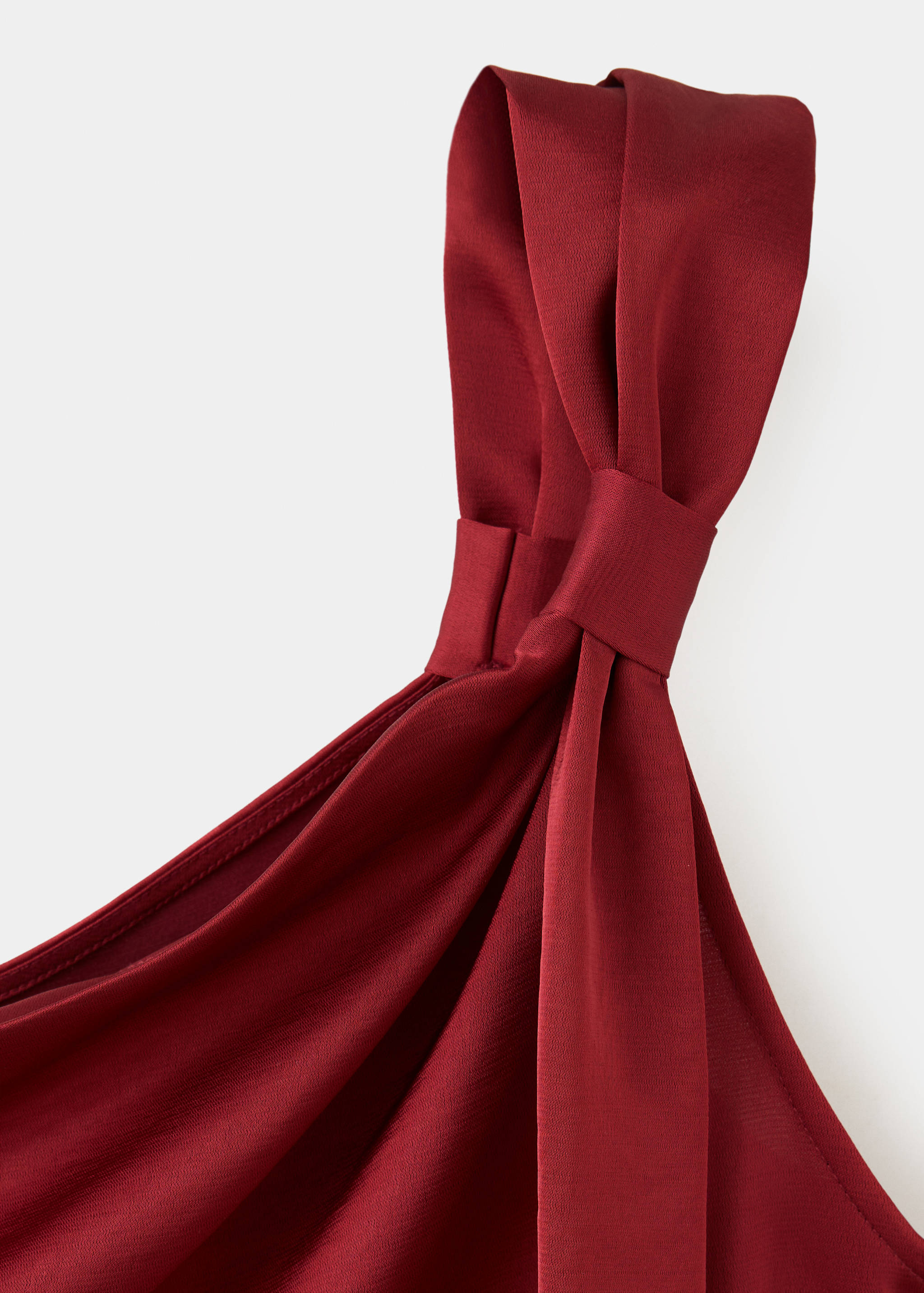 Burgundy dress fabric and knotted strap detail.