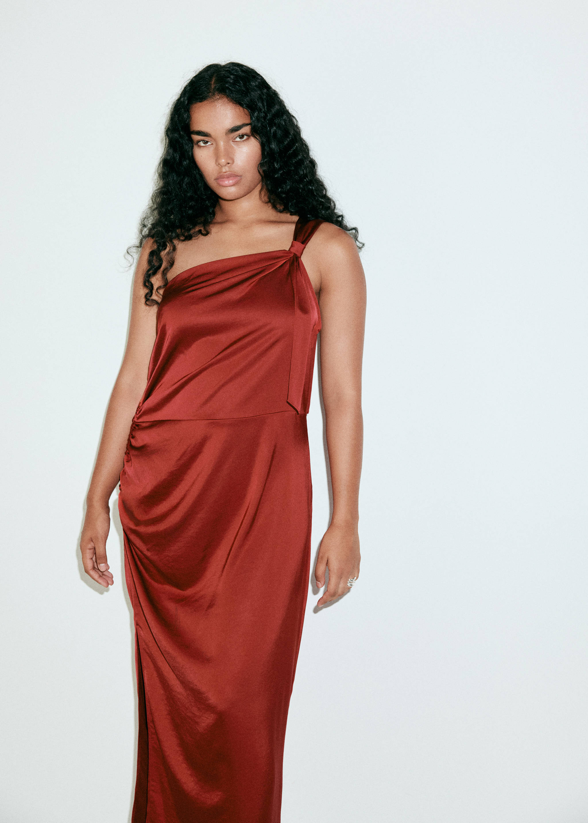 Reddish-brown satin one-shoulder midi dress with shoulder knot detail.